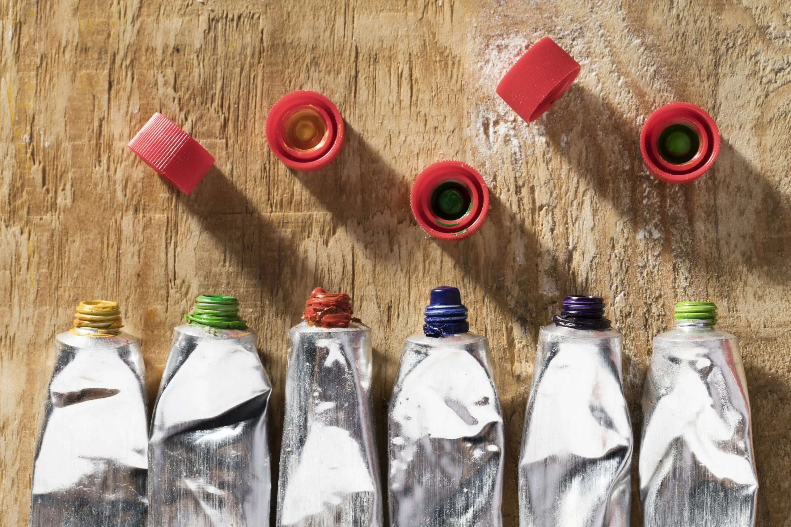 UAE adhesives market outlook to 2030 top-view-paint-tubes-wooden-surface-scaled
