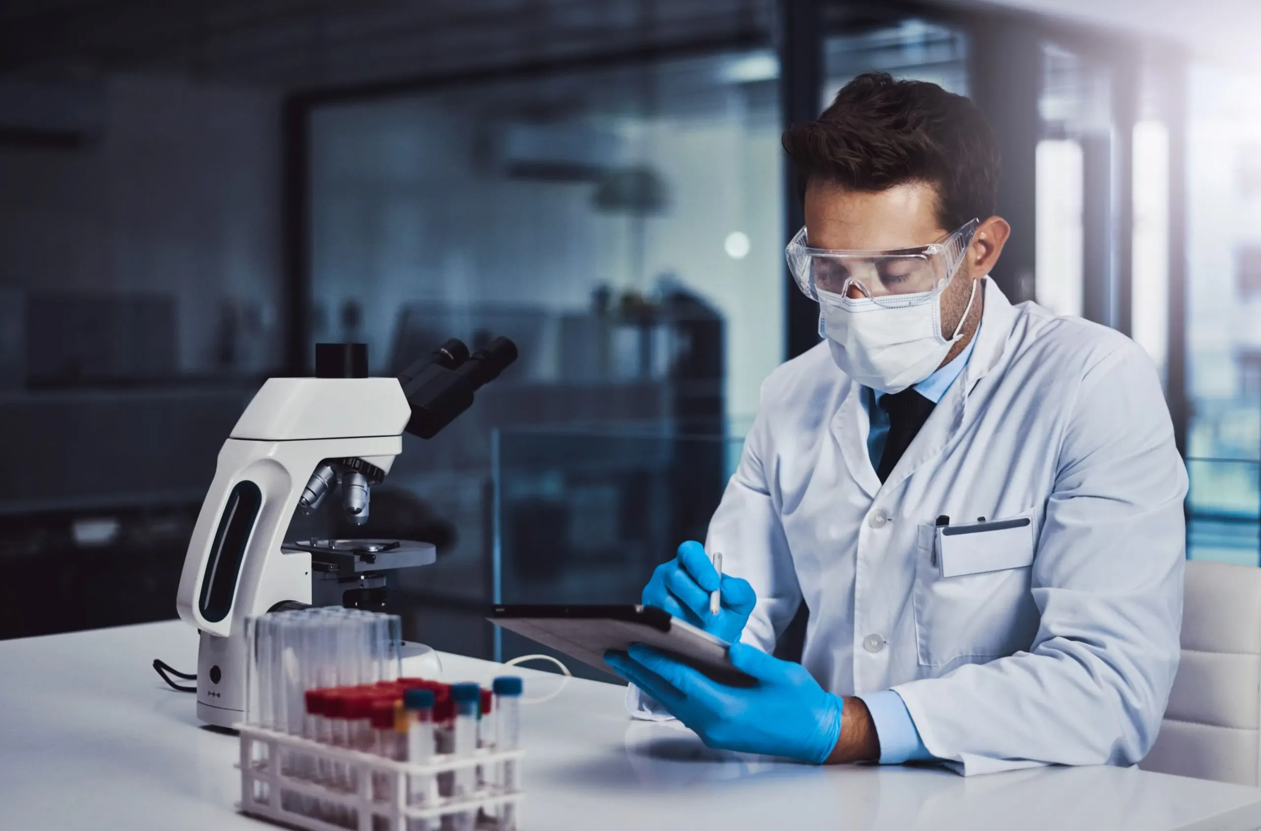 Qatar Diagnostic Labs Market Outlook to 2030 lab-healthcare-man-with-tablet-scientific-research-data-collection-test-results-ppe-clinic-medical-professional-investigation-cure-cancer-immunotheraphy-treatment-1-scaled