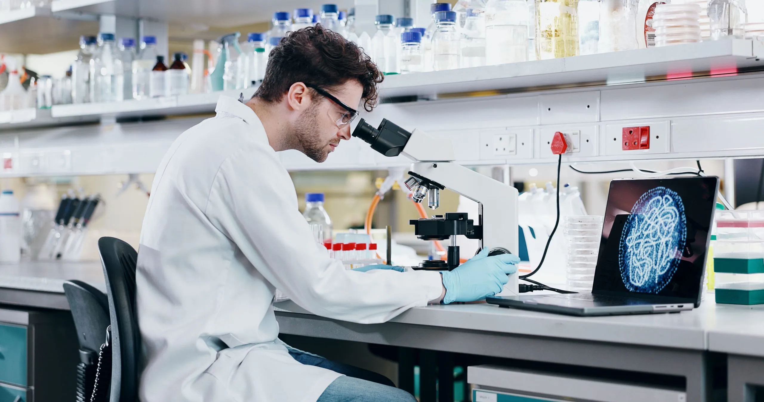 UAE Laboratory Reporting Systems Market Outlook 2030 medical-research-man-with-microscope-science-check-experiment-cancer-treatment-person-scientist-employee-with-lab-equipment-laptop-cure-development-with-particles-biotech-2-scaled