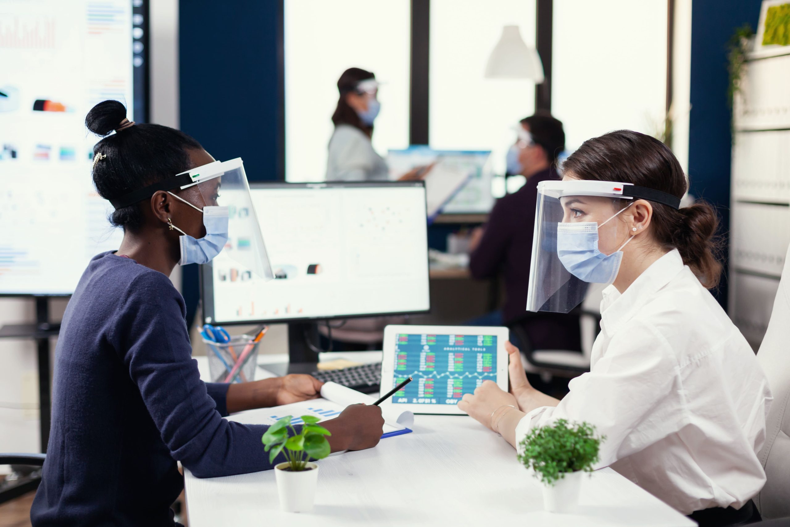 KSA Laboratory Workflow Management Solutions Market Outlook to 2030 multiethnic-coworkers-analysing-financial-graph-covid19-diverse-group-business-people-working-communicating-together-creative-office-with-new-normal-respecting-social-distance-1-scaled