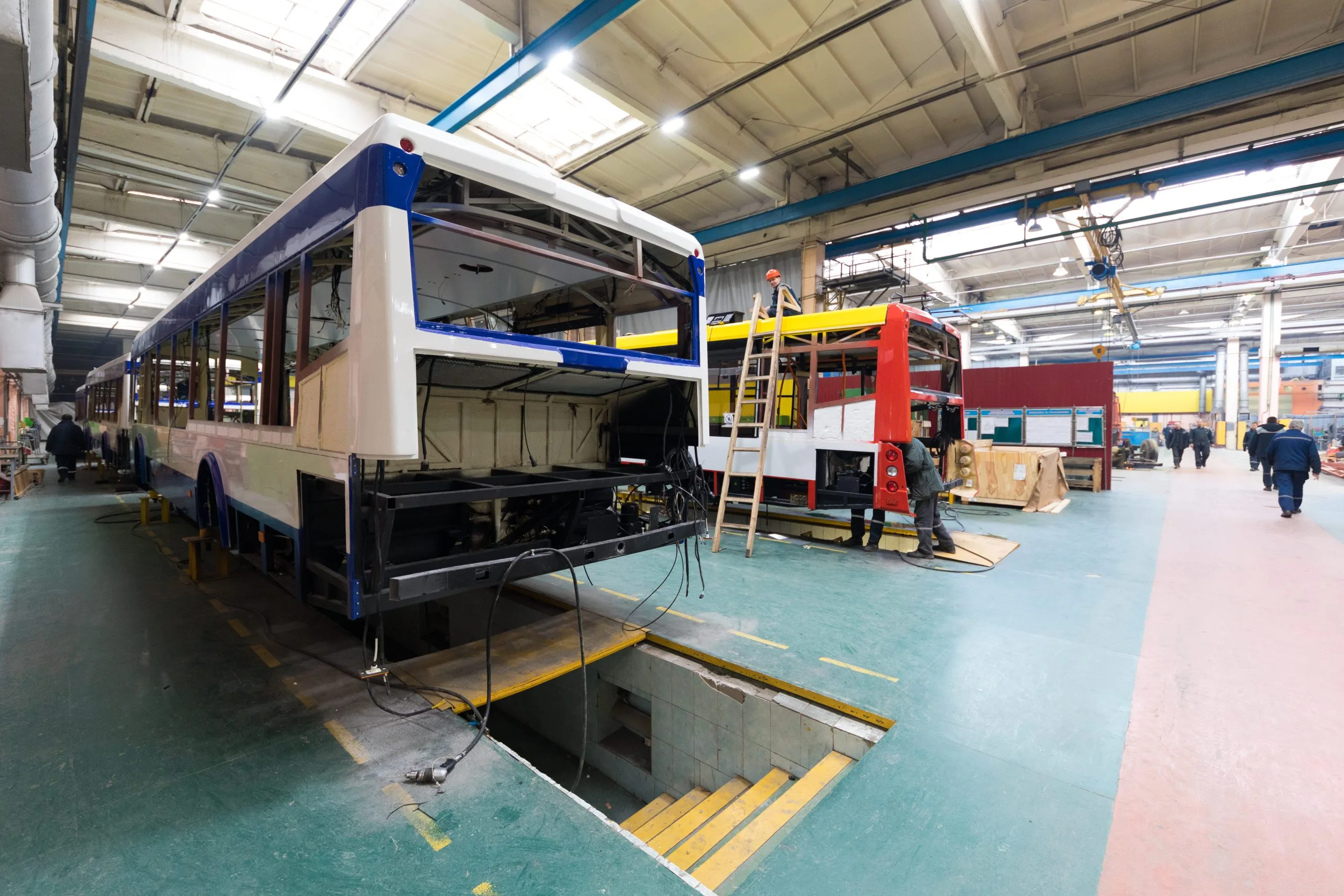 Singapore helicopter services Market outlook to 2035 one-working-day-modern-automatic-bus-manufacturing-with-unfinished-cars-workers-protective-uniform-automotive-parts-background-2-scaled