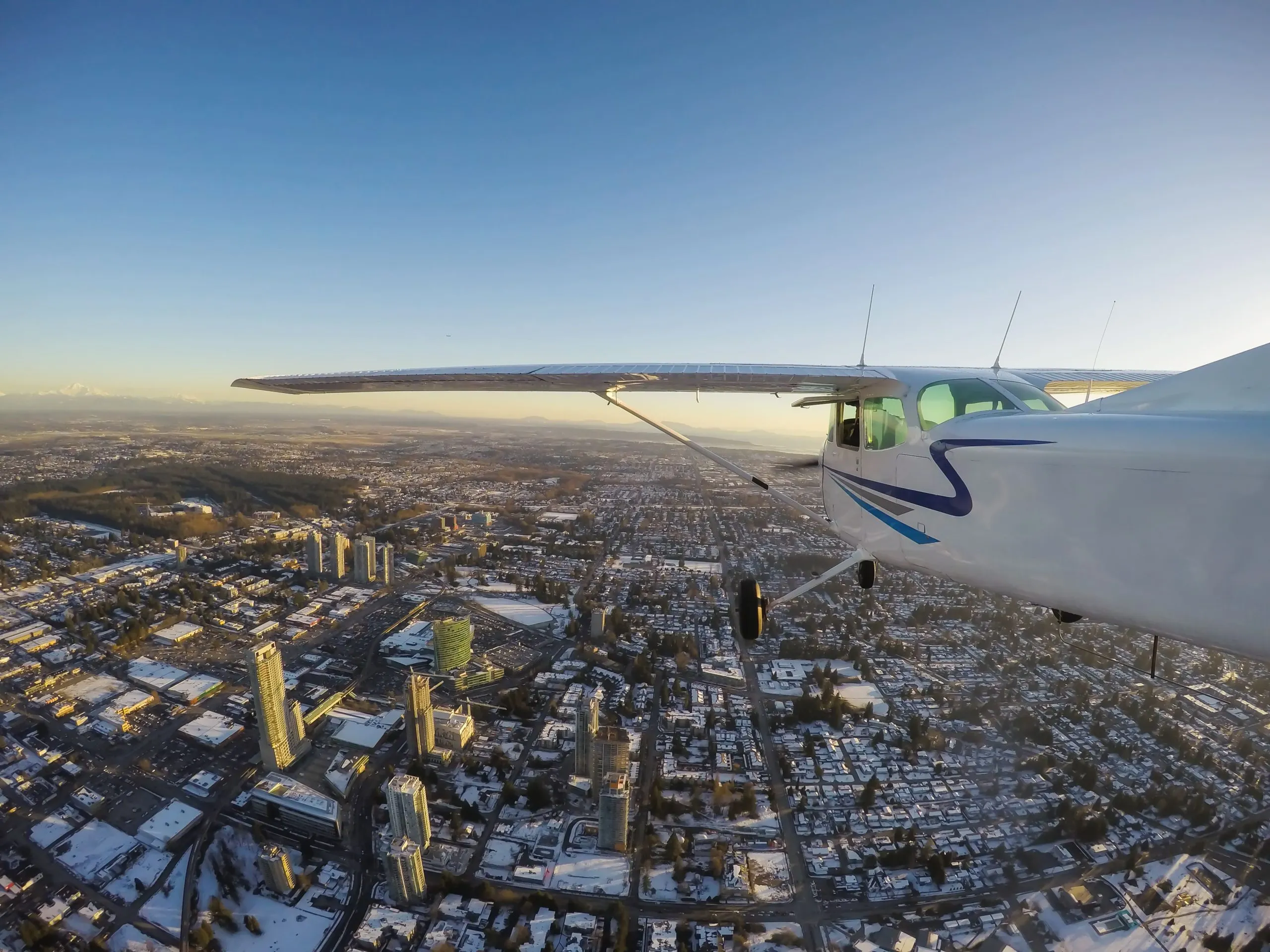 Qatar glider aircraft Market outlook to 2035 small-airplane-flying-city-vibrant-winter-sunset-1-scaled