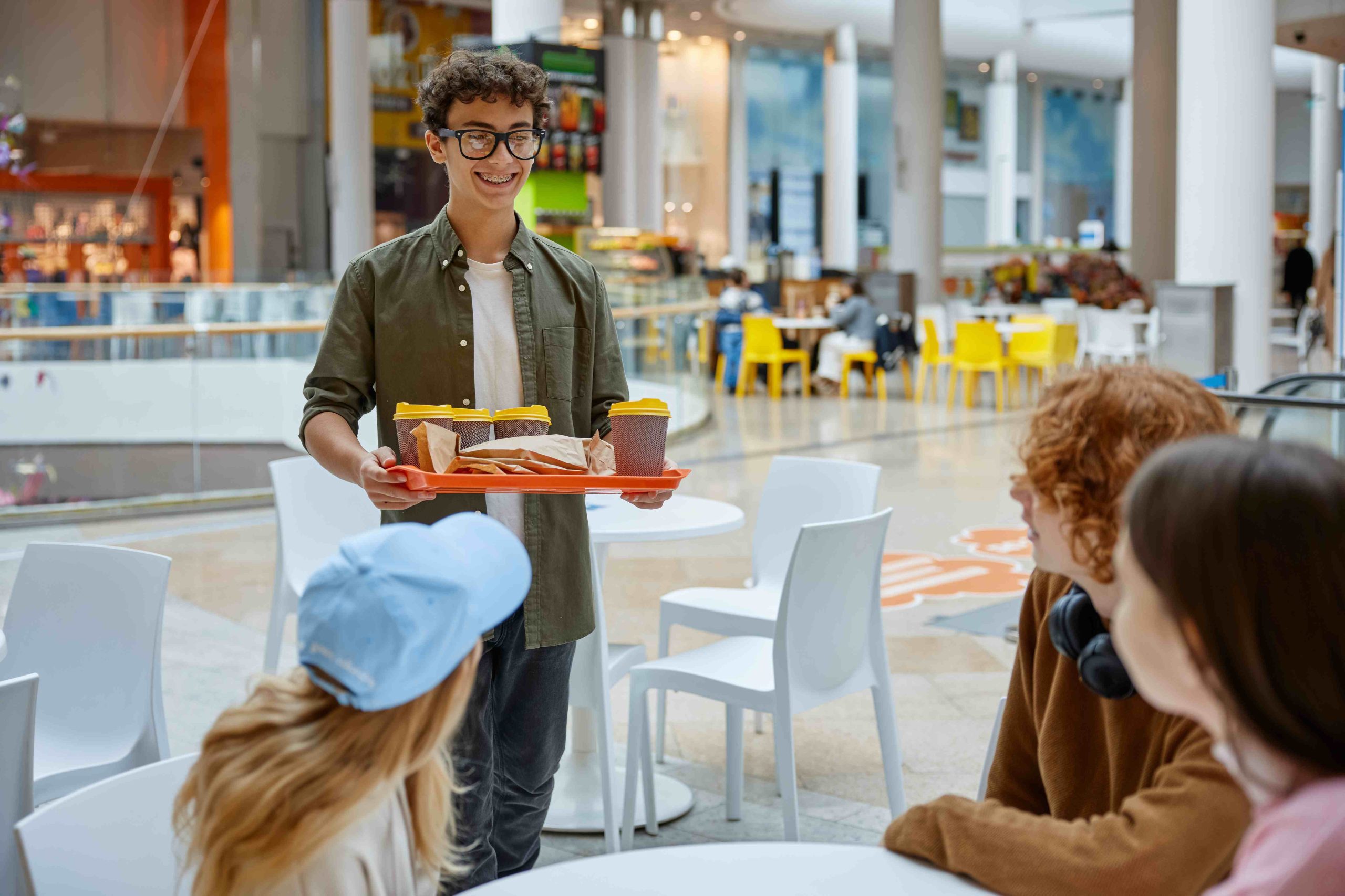teenage-friends-taking-break-fun-time-shopping-mall_compressed-scaled