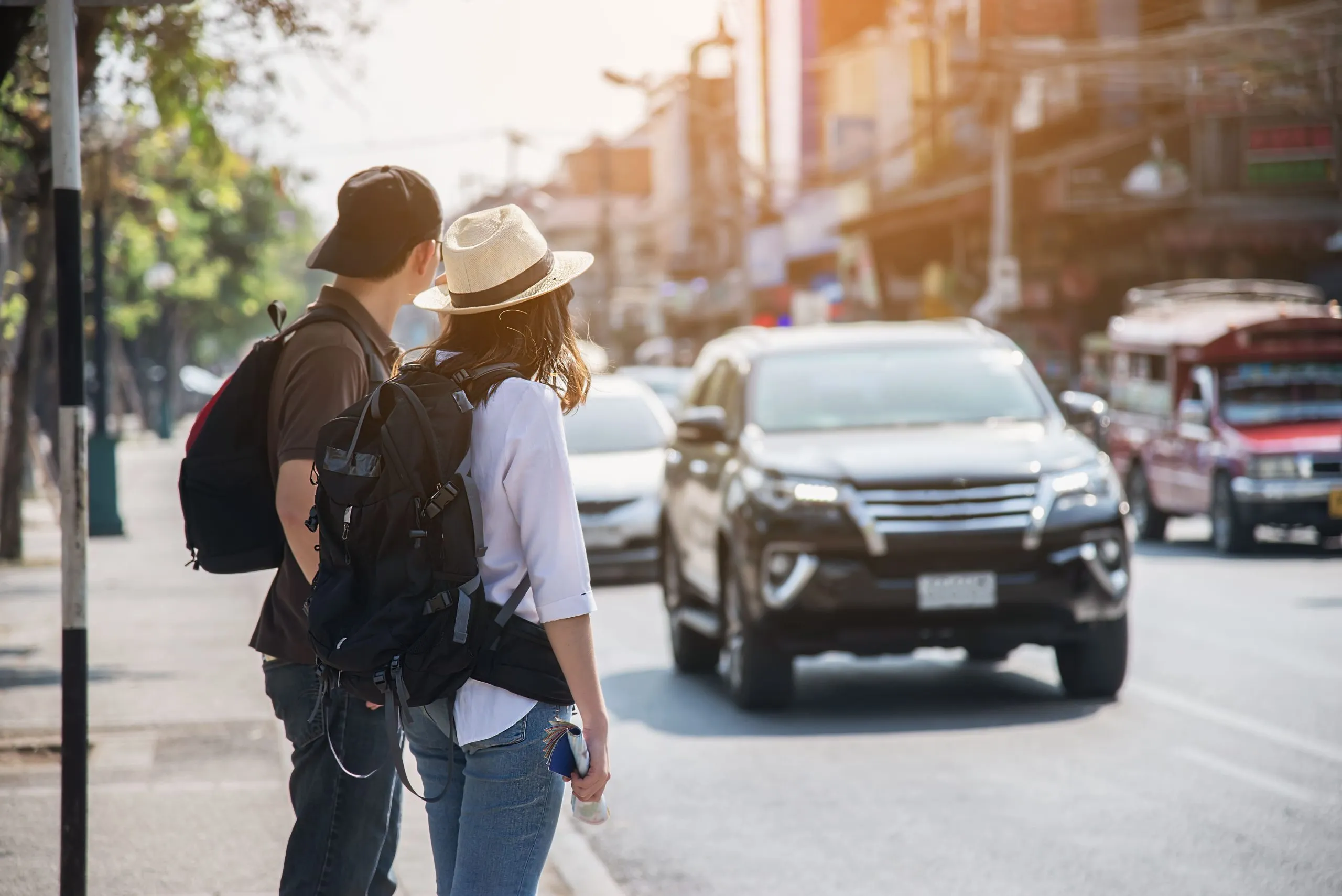 Philippines Ride-Hailing Services Market Outlook 2030 asian-couple-tourist-crossing-road-1-scaled