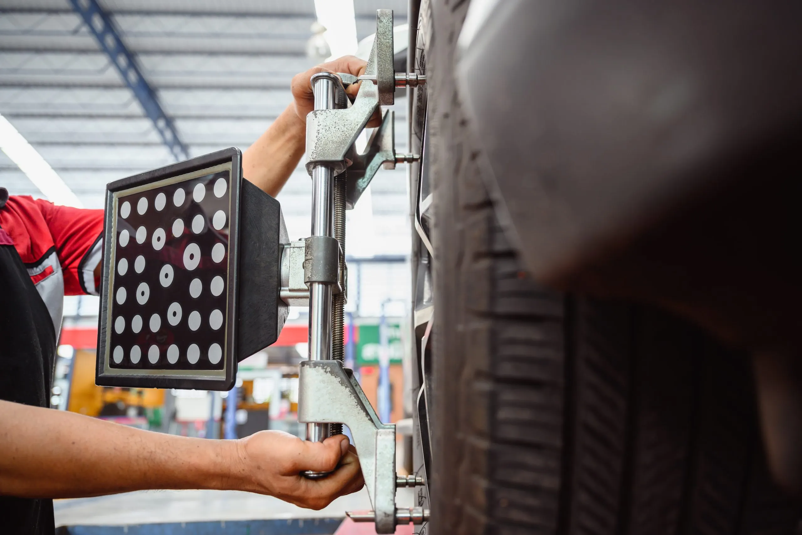 USA Tire Pressure Monitoring Systems (TPMS) Market Outlook 2030 auto-service-mechanic-installing-wheel-alignment-sensor-tire-vehicle-suspension-alignment-adjustment-set-car-wheel-center-auto-repair-station-scaled