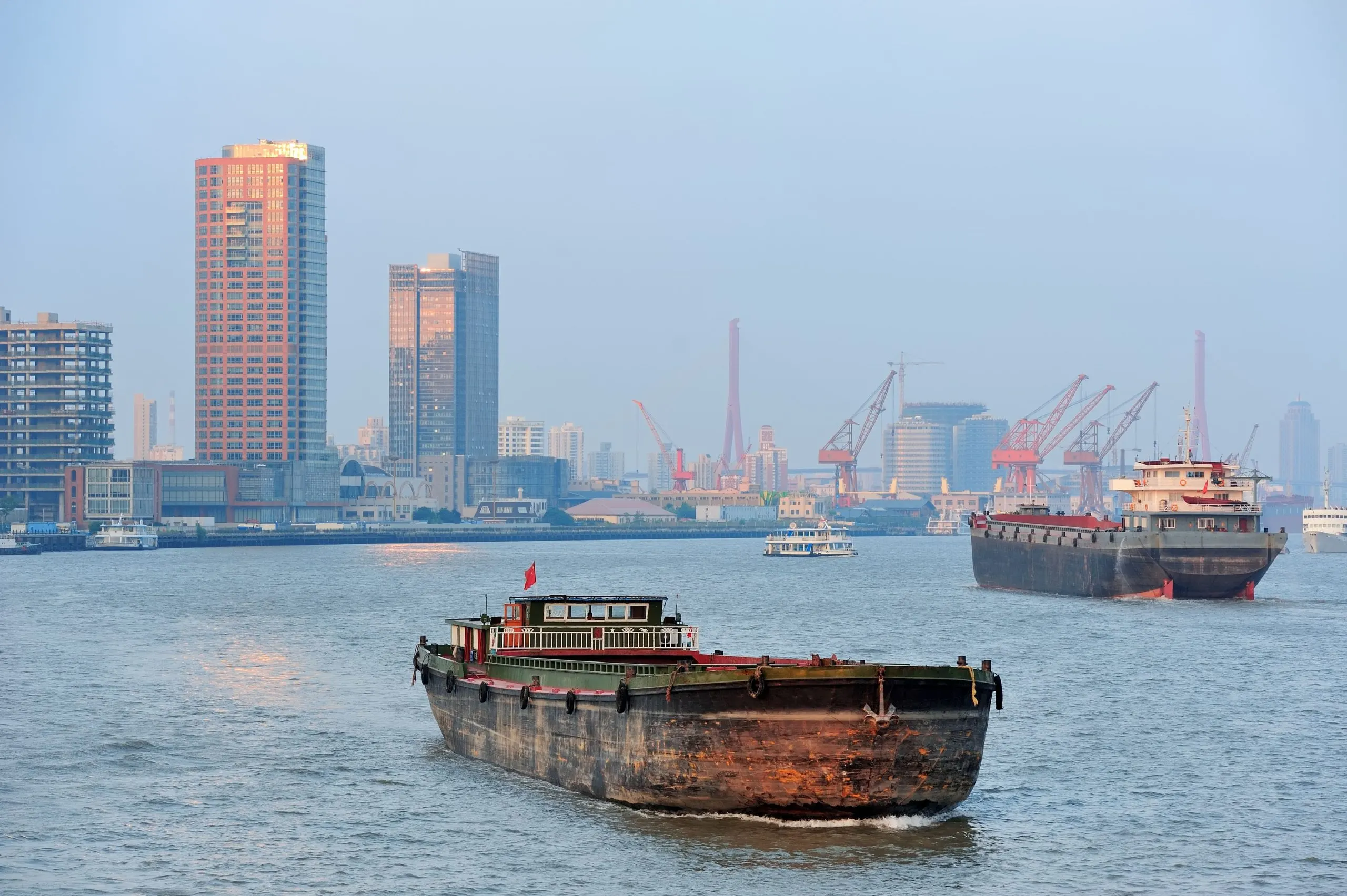 Australia naval vessels Market outlook to 2035 boat-huangpu-river-with-shanghai-urban-architecture-1-scaled