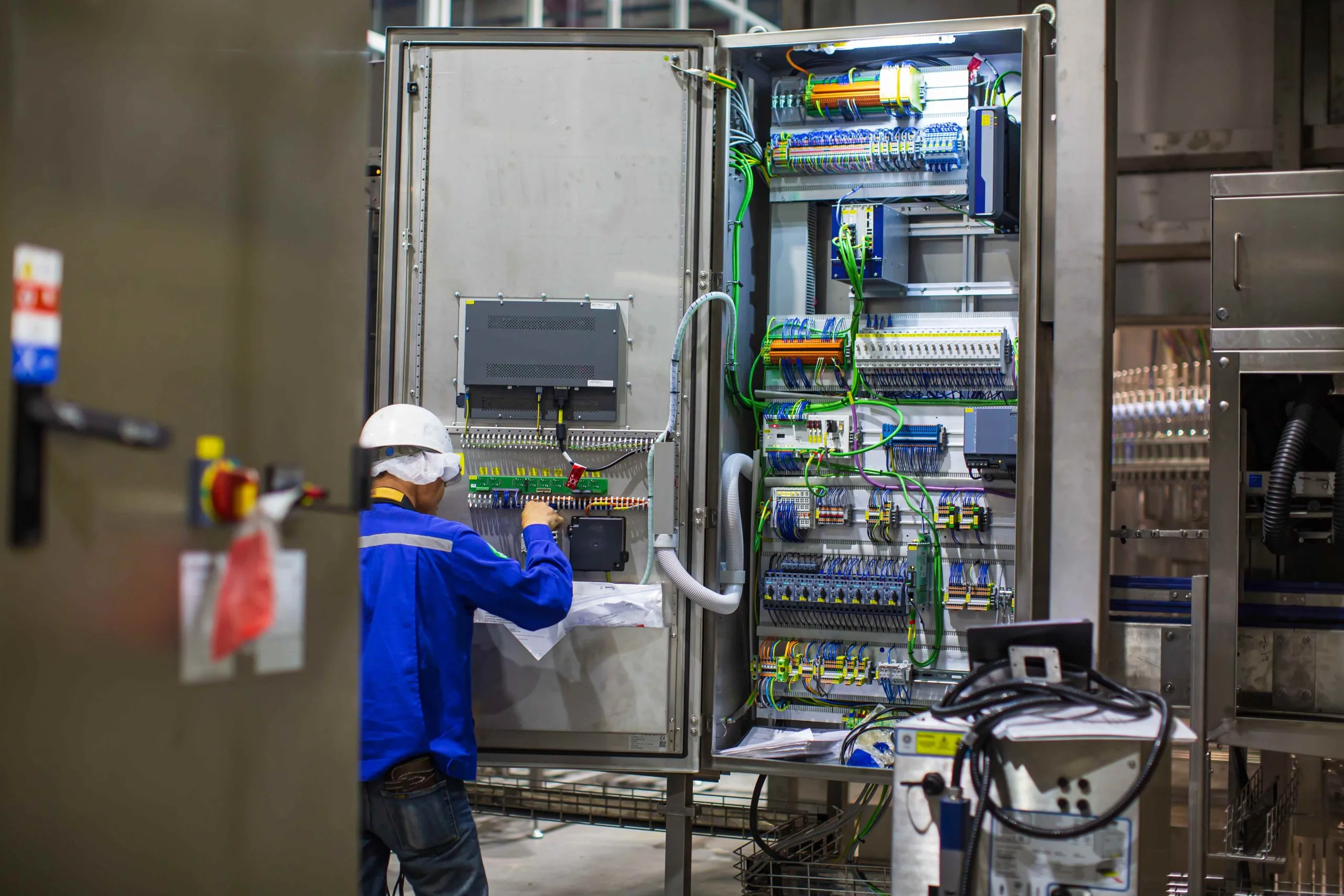 Australia electric wiring interconnection systems Market outlook 2035 electrician-engineer-tests-electrical-box-control-machine-installations-wires-inside-factory_compressed-scaled