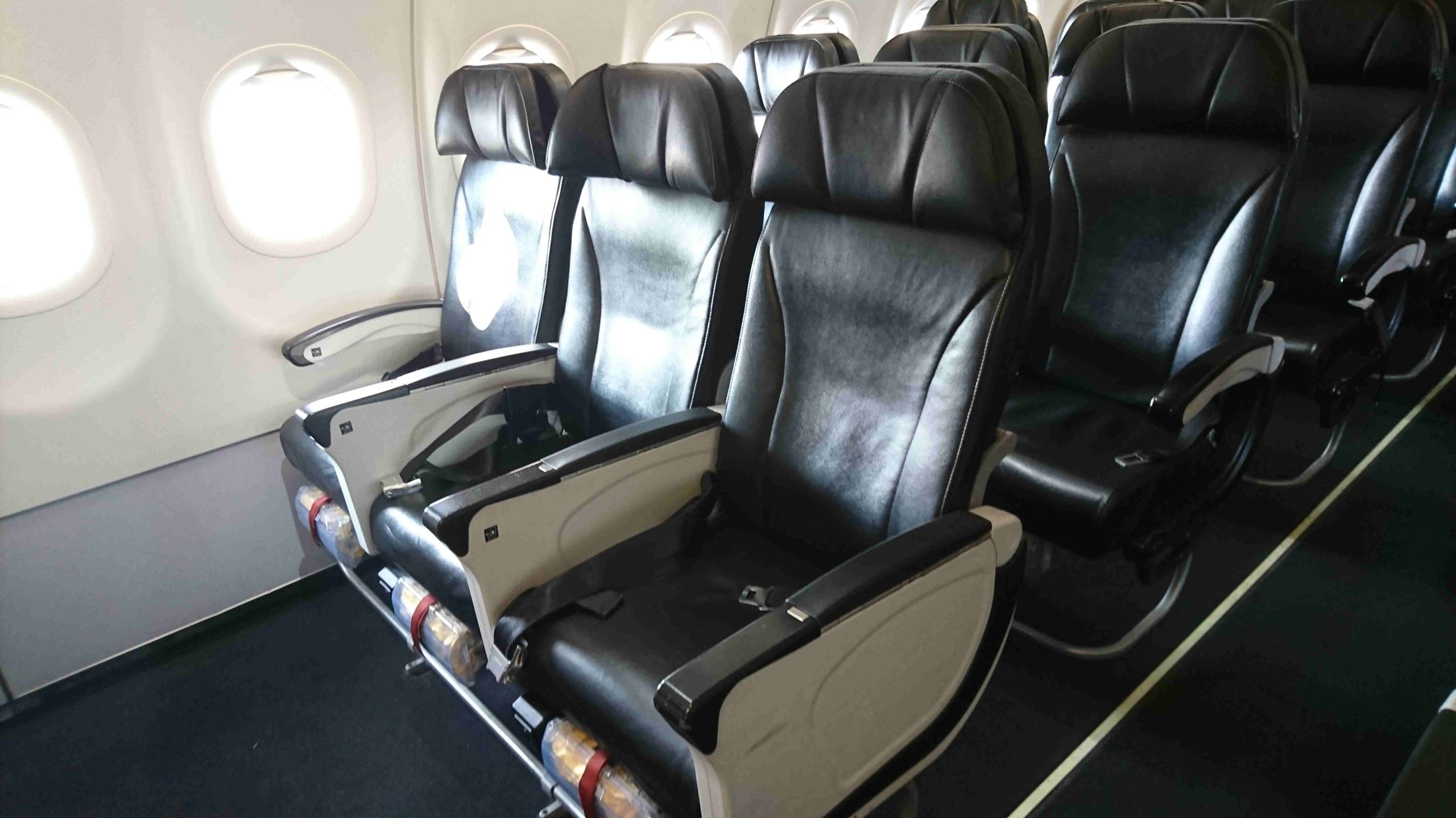 empty-black-seats-airplane_compressed-scaled