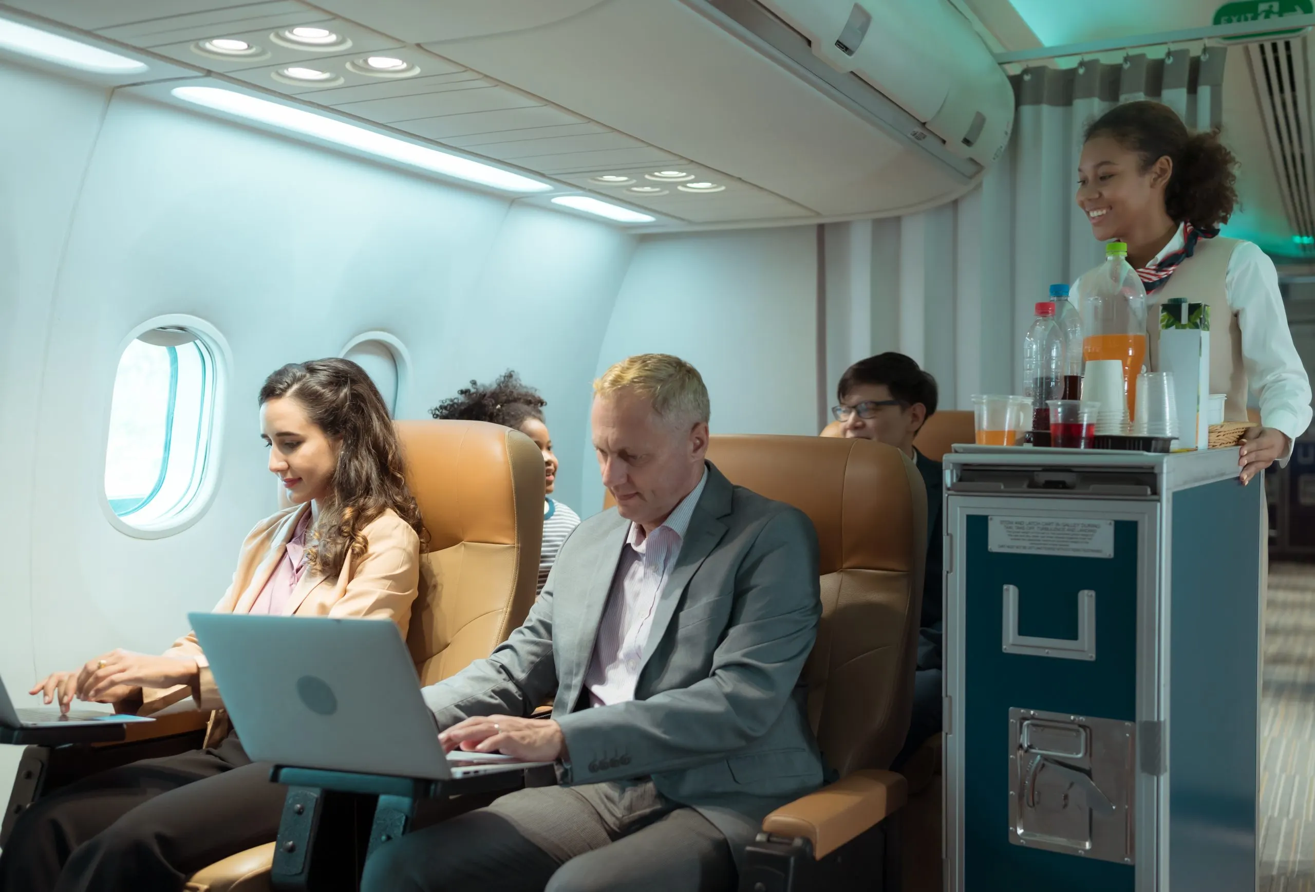 Middle east commercial aircraft cabin seating Market outlook 2035 flight-attendant-serving-food-drinks-passengers-scaled