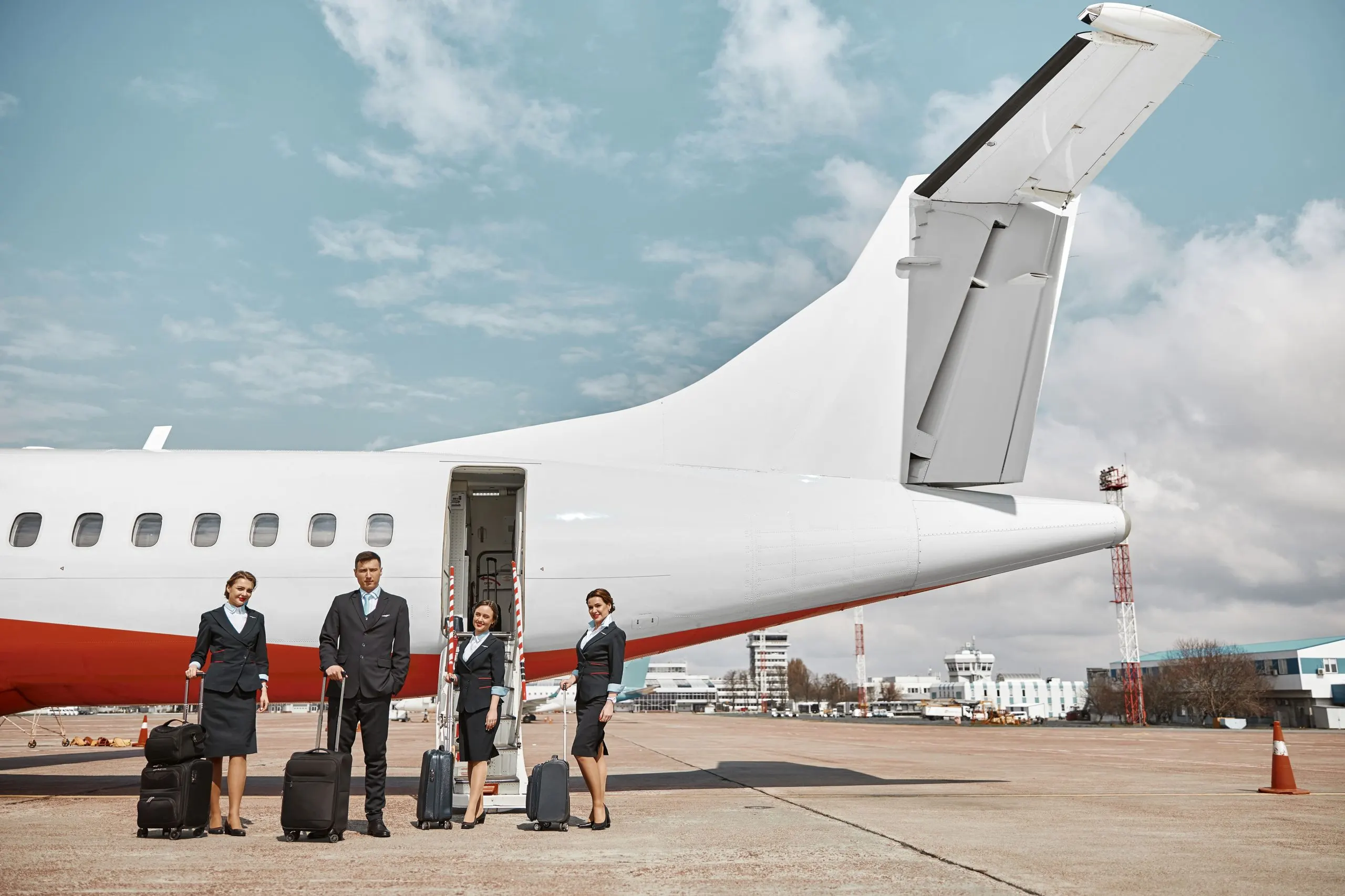 US charter jet services Market outlook 2035 flight-attendant-stewardesses-standing-runway-near-airplane-jet-modern-passenger-plane-man-women-with-baggage-wear-uniform-teamwork-civil-commercial-aviation-air-travel-concept-1-scaled