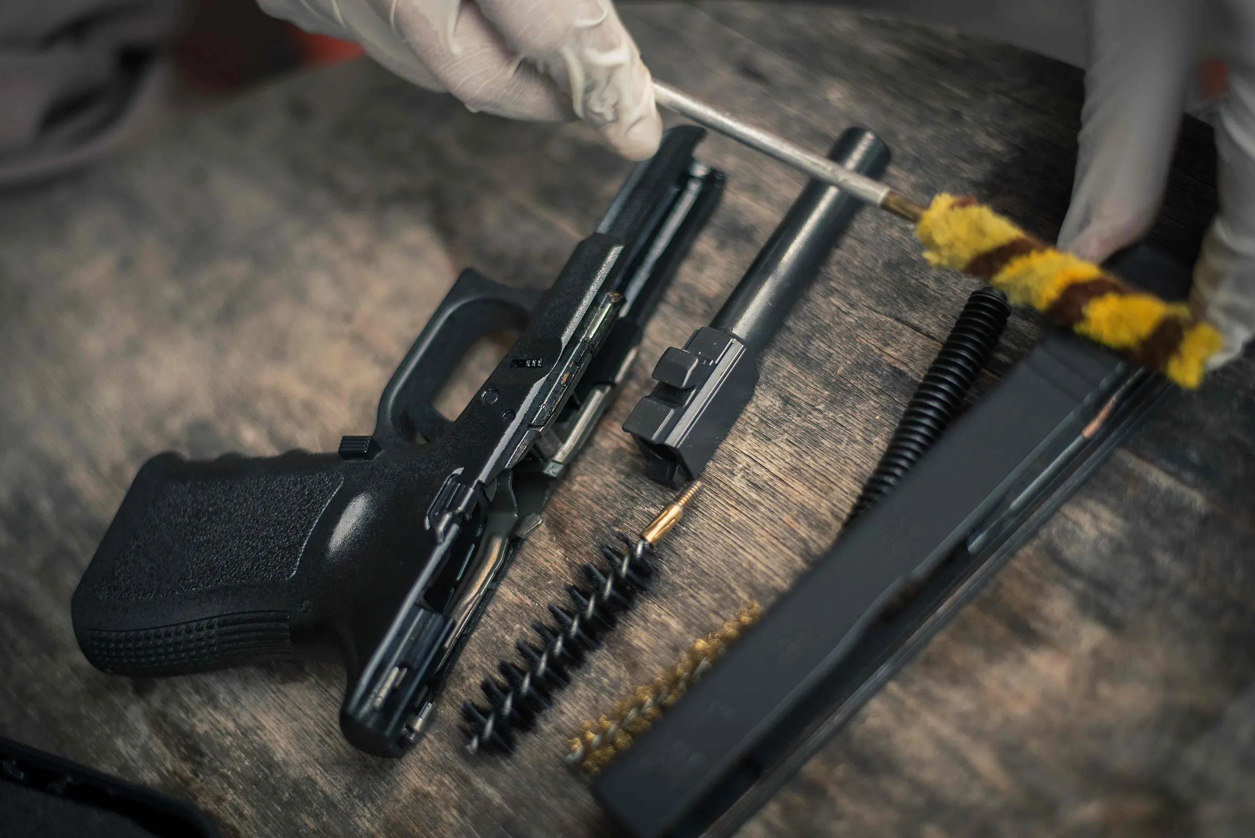 KSA Service Handgun Market Outlook to 2035 gunsmith-is-sitting-around-cleaning-gun-disassembling-maintaining-pistol_compressed-scaled