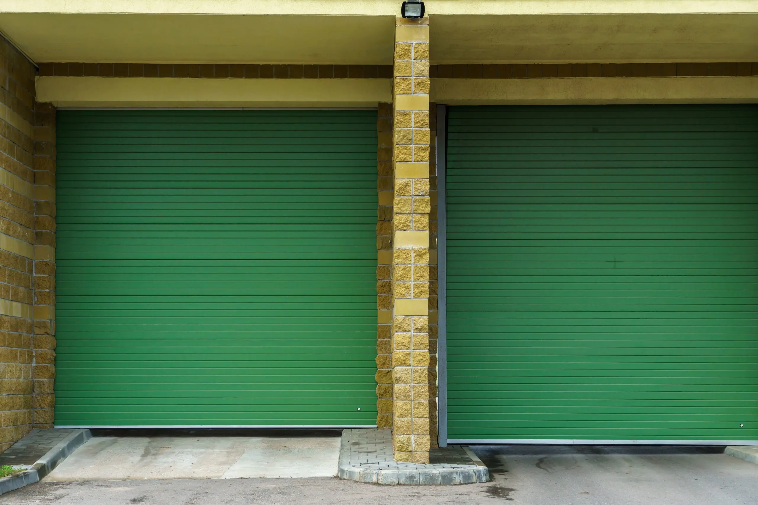 USA Door Panels Market Outlook 2030 large-modern-garage-made-beige-brick-green-roller-gates-video-surveillance-system-entrance-garage-safe-conditions-storing-cars-property-scaled