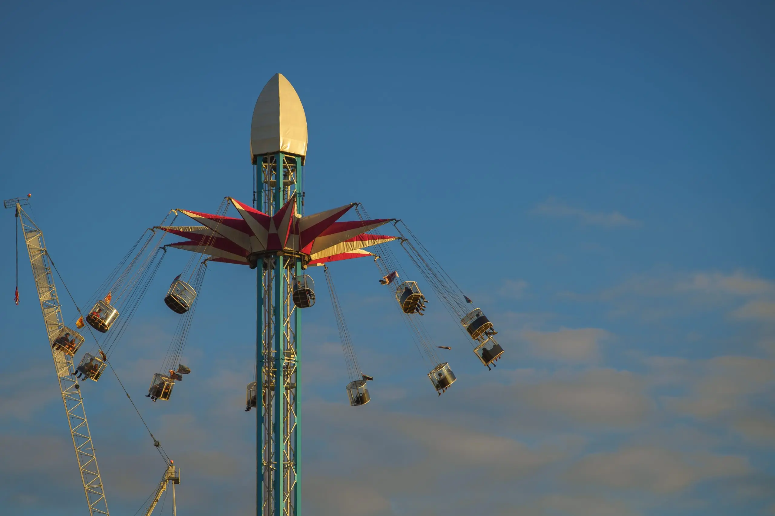 US Meo satellite Market outlook 2035 low-angle-view-amusement-park-ride-against-blue-sky-scaled