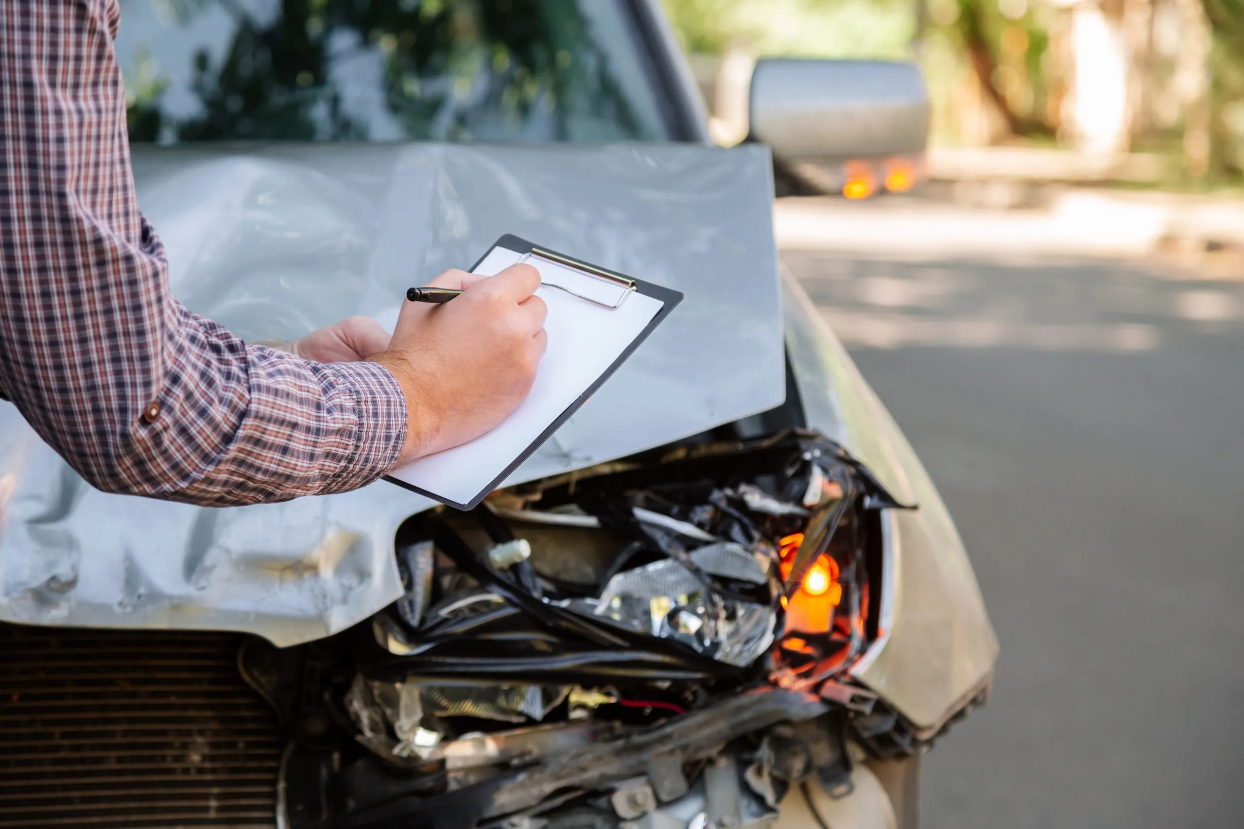 USA Vehicle Crash Test Systems Market Outlook 2030 male-insurance-agent-with-auto-insurance-blank-against-destroyed-car-car-crash-traffic-accident-road-smashed-broken-front-auto-headlight-car-accident-auto-life-health-insurance-scaled