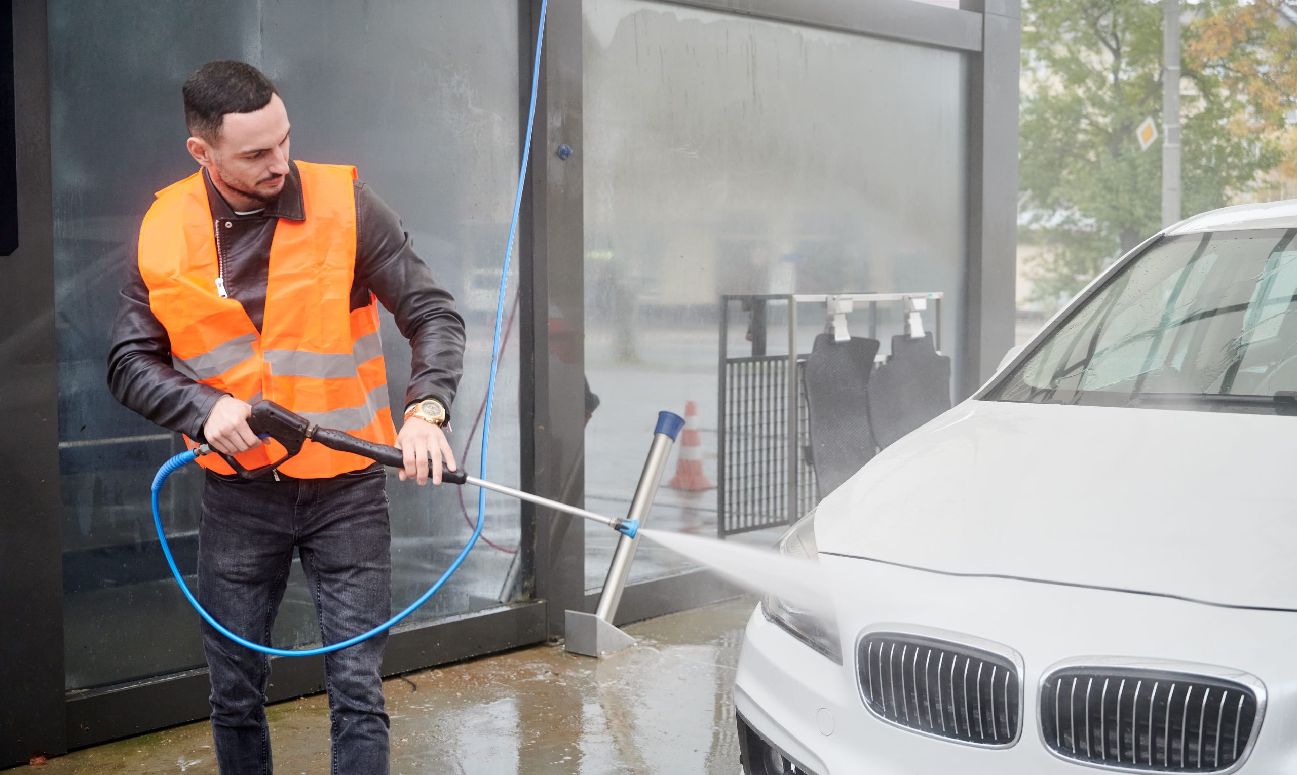 man-washing-car-carwash-station-wearing-orange-vest-1-scaled