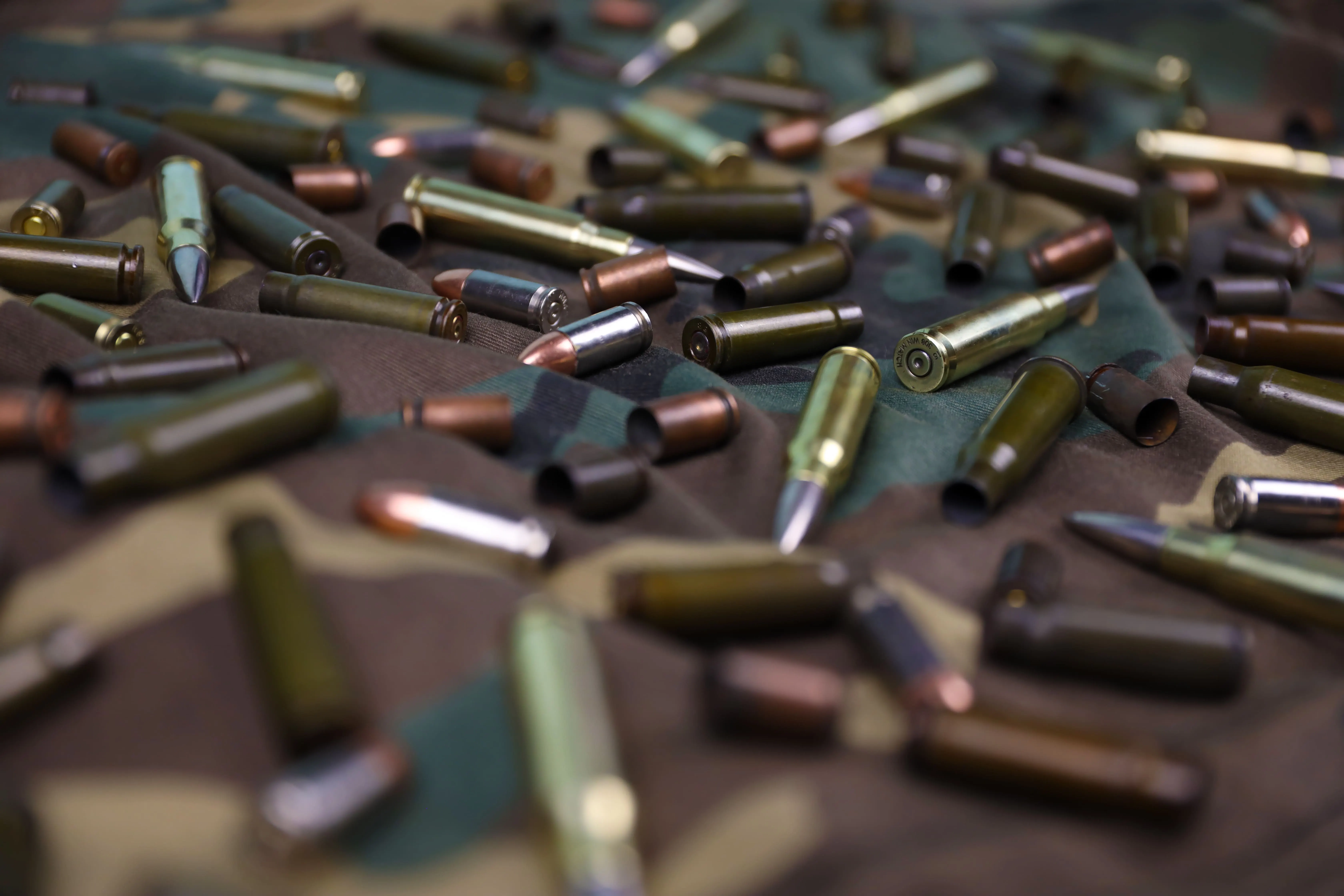 US ammunition Market outlook 2035 many-rifle-bullets-cartridges-dark-camouflage-background-2-1