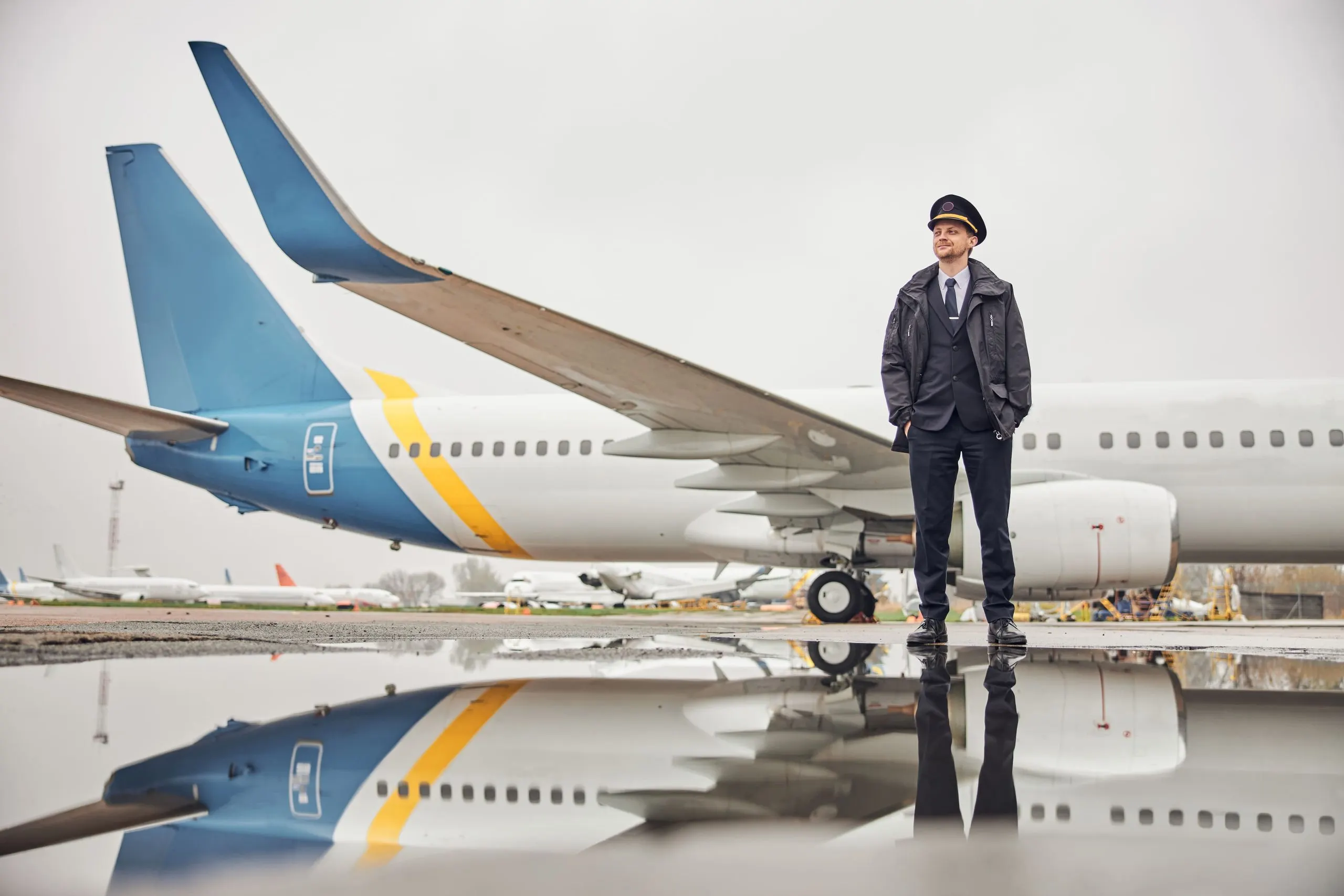 Singapore business jet ground handling services Market outlook to 2035 portrait-happy-confident-caucasian-airplane-crew-near-plane-1-scaled