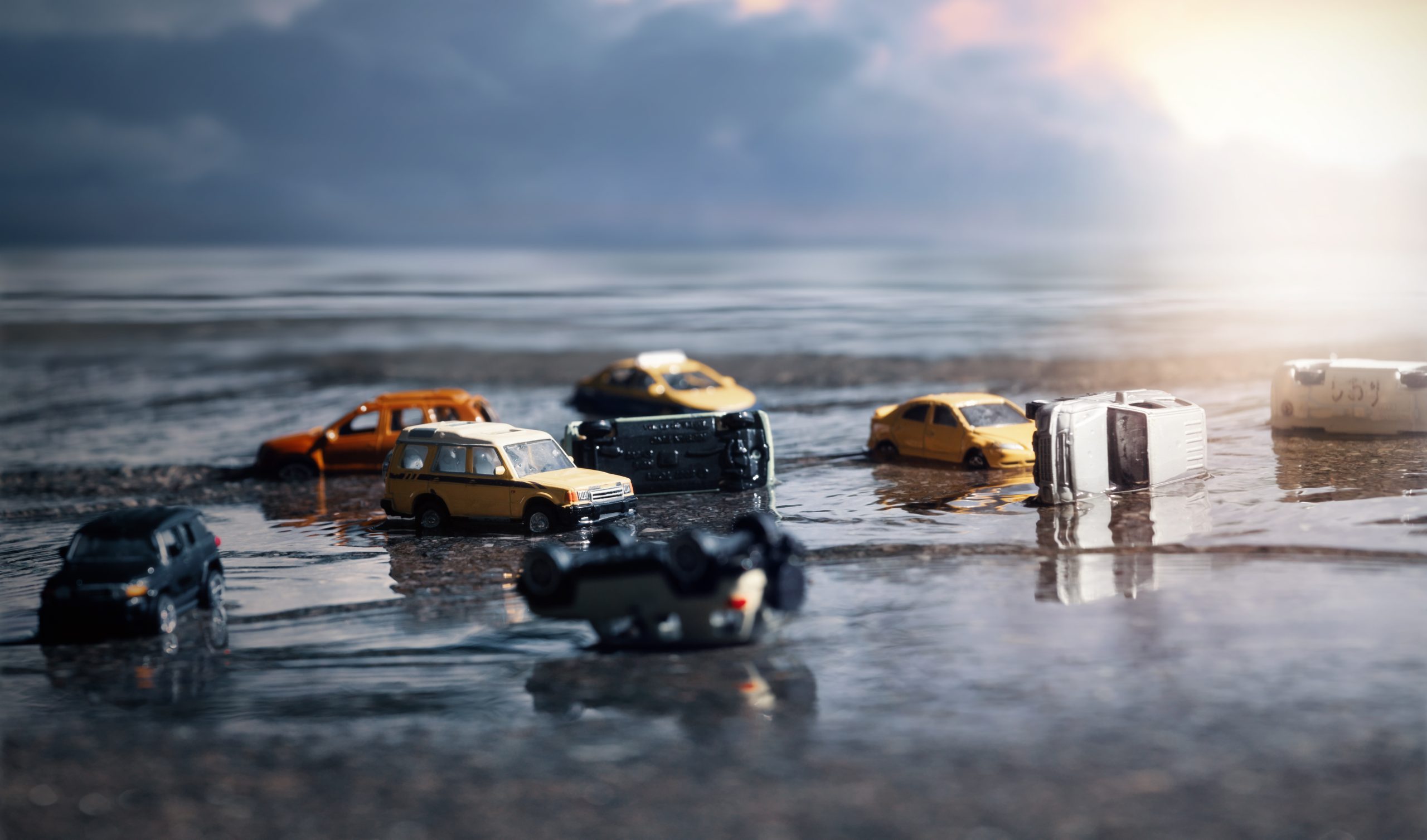 scene-cars-miniature-toy-model-flood-from-natural-disasters-heavy-rain-typhoon-hurricane-transportation-car-insurance-concept-scaled