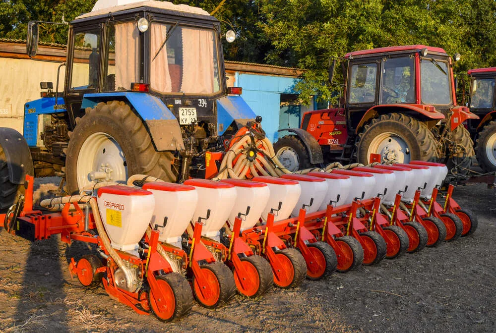 India Used Agricultural Implements Market Outlook to 2035 yellow-tractor-with-attached-grederom-makes-ground-leveling-1