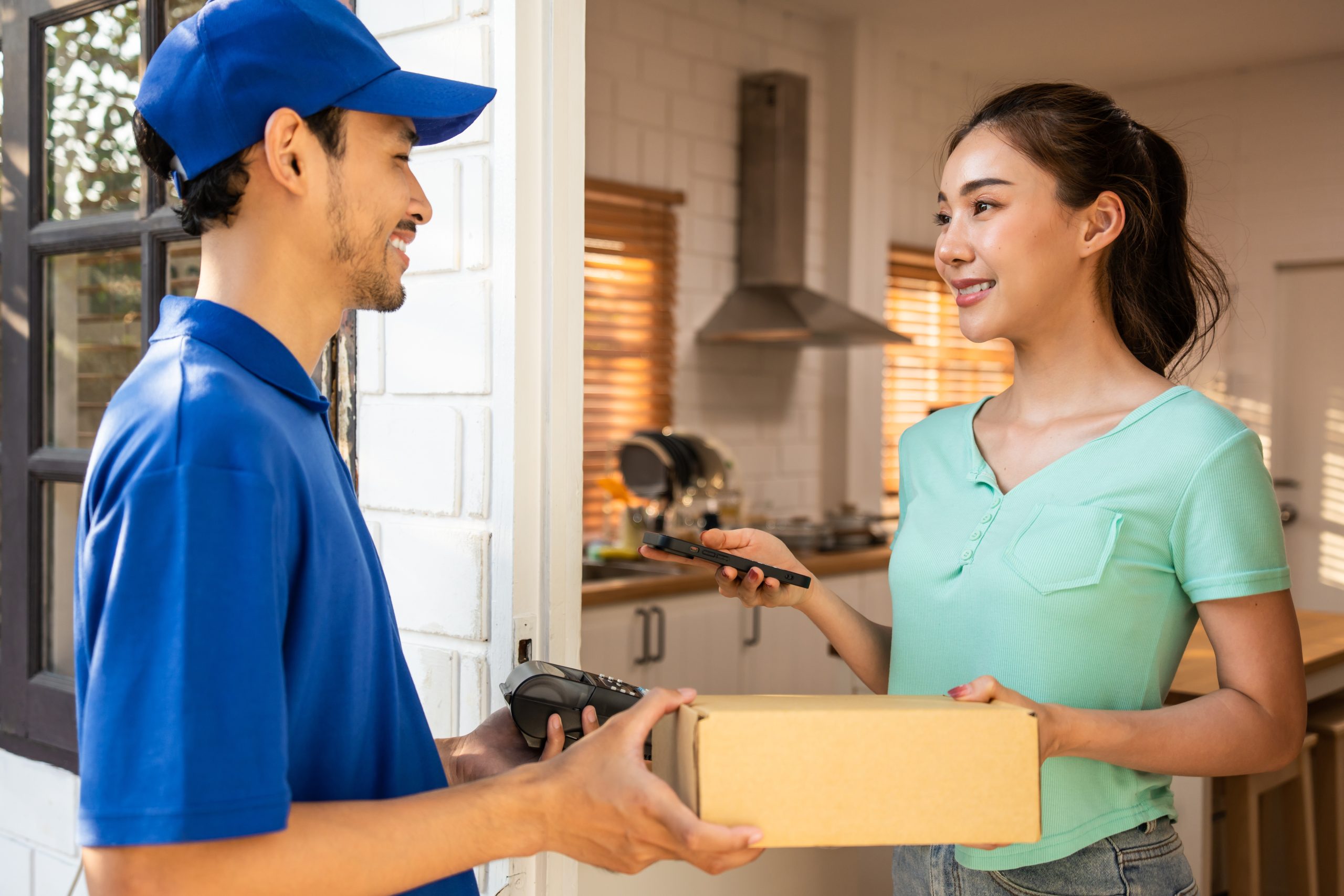 France CEP Market Outlook to 2035 asian-young-delivery-man-delivering-package-female-customer-home-attractive-postman-blue-uniform-working-deliver-box-fruit-vegetable-groceries-woman-infront-door-house-1-scaled