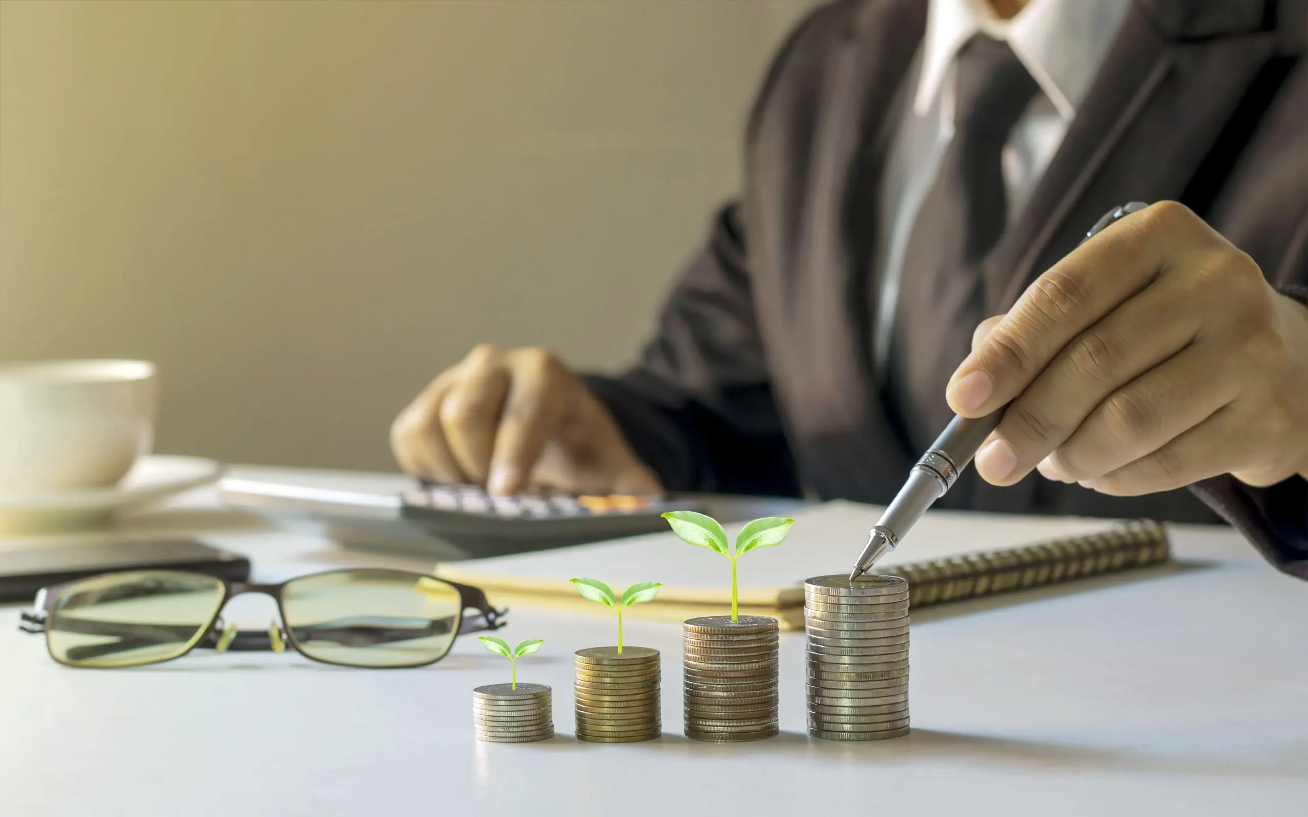 France Wealth Management Market Outlook to 2035 businessman-holding-pen-tree-growing-coin-planning-ideas-investing-growing-money-1-scaled