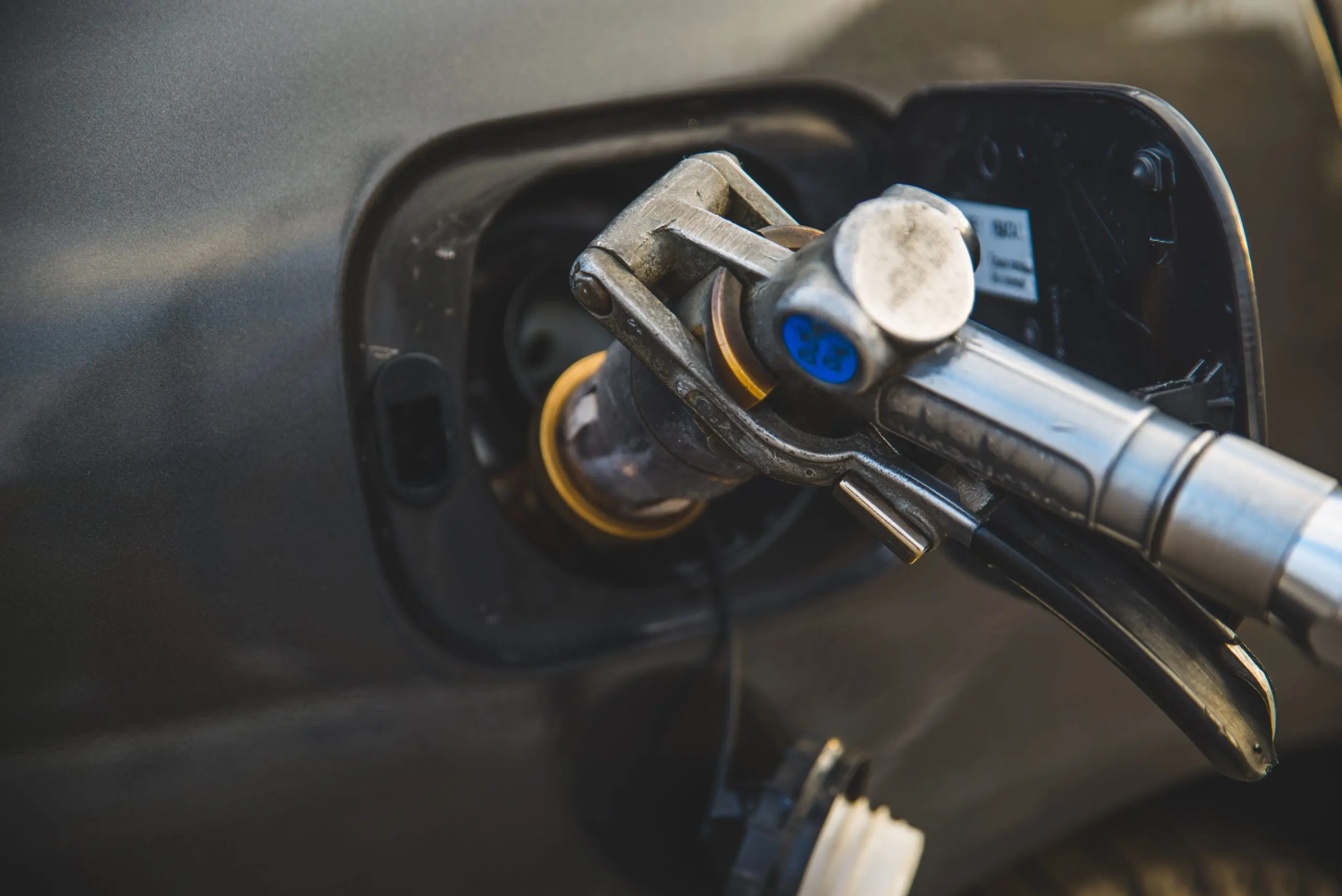 Philippines Fuel Pumps Market Outlook 2035 car-fuel-up-with-gas-close-up-refueling-gun-neck-tank-scaled