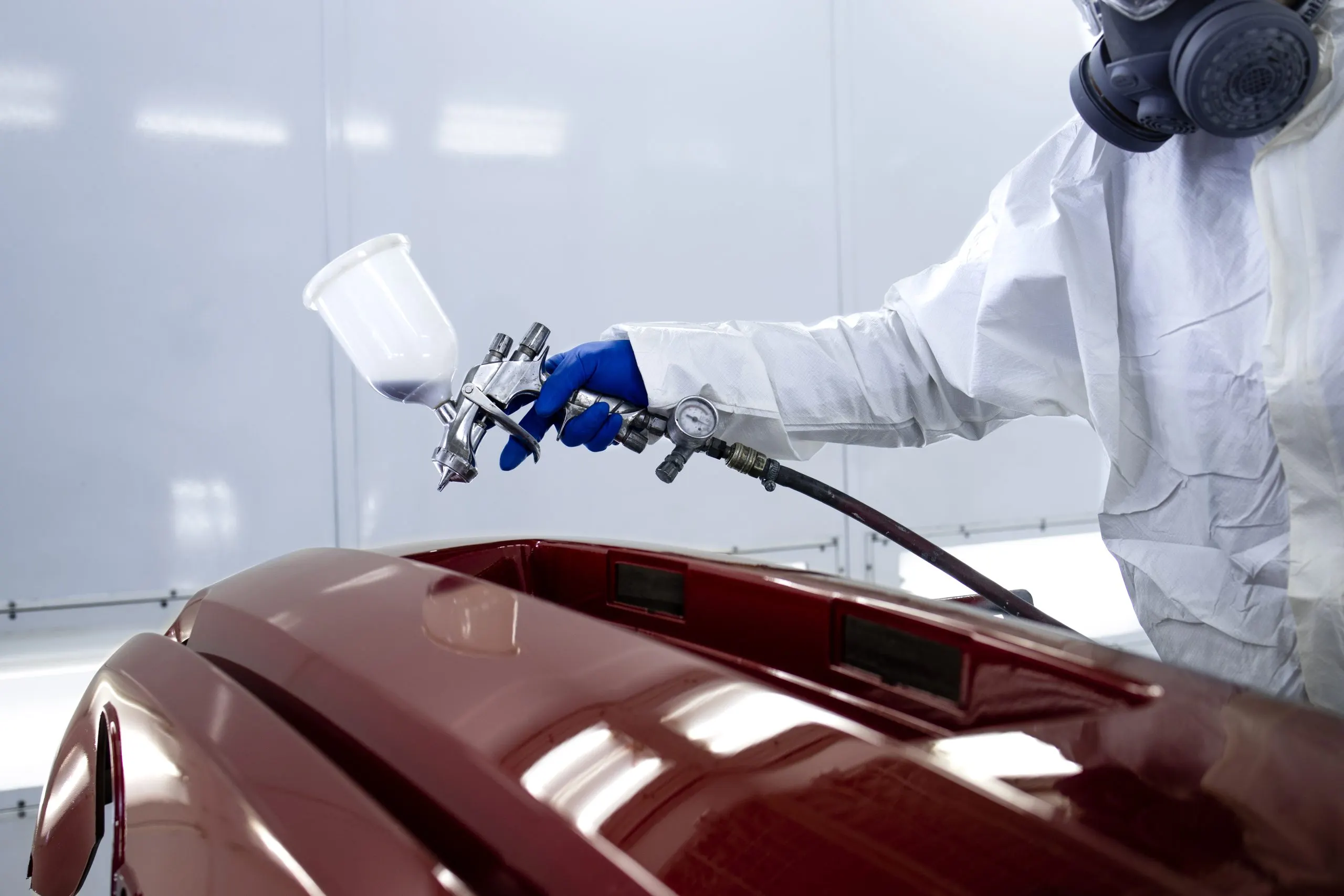USA Automotive Paints Market Outlook to 2035 car-painter-protective-clothes-mask-painting-automobile-bumper-with-metallic-paint-varnish-chamber-workshop-scaled