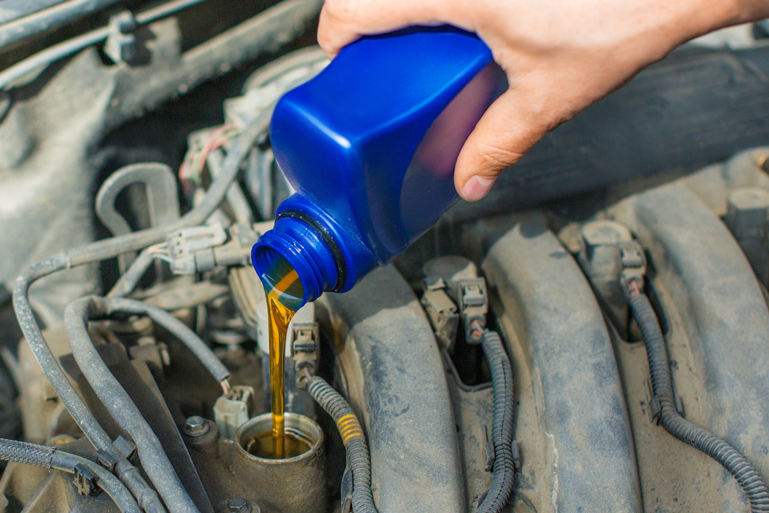 USA Brake Fluids Market Outlook to 2035 close-up-photo-male-hand-fill-car-engine-by-oil-scaled