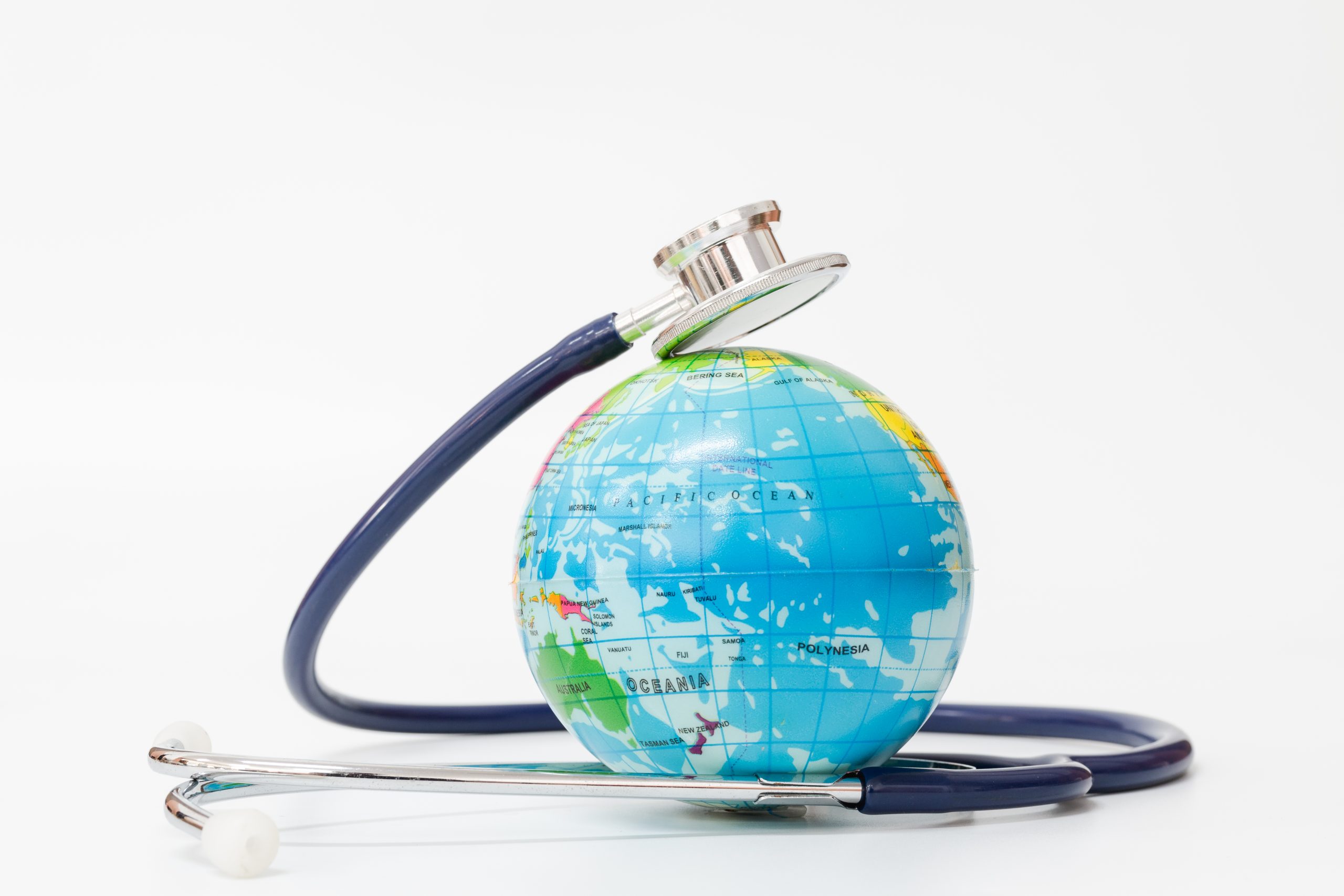 close-up-stethoscope-globe-against-white-background-scaled