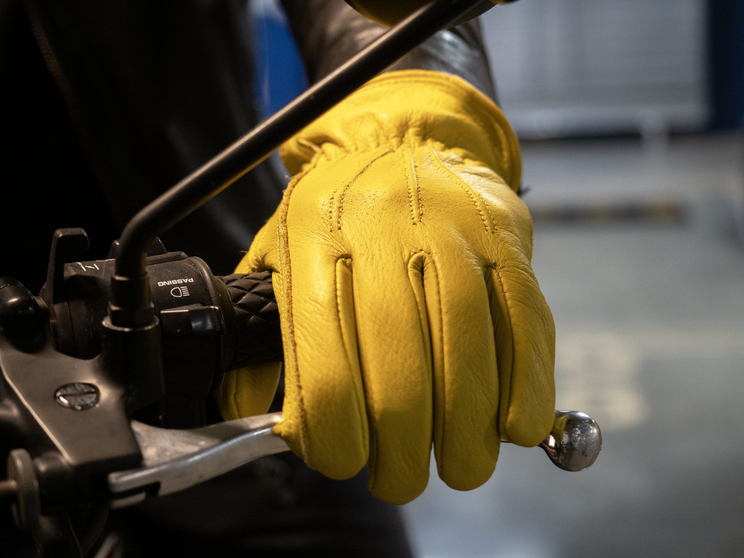 Philippines Automotive Glove Compartments Market Outlook 2035 closeup-biker-yellow-leather-gloves-holding-motorcycle-handlebars-scaled