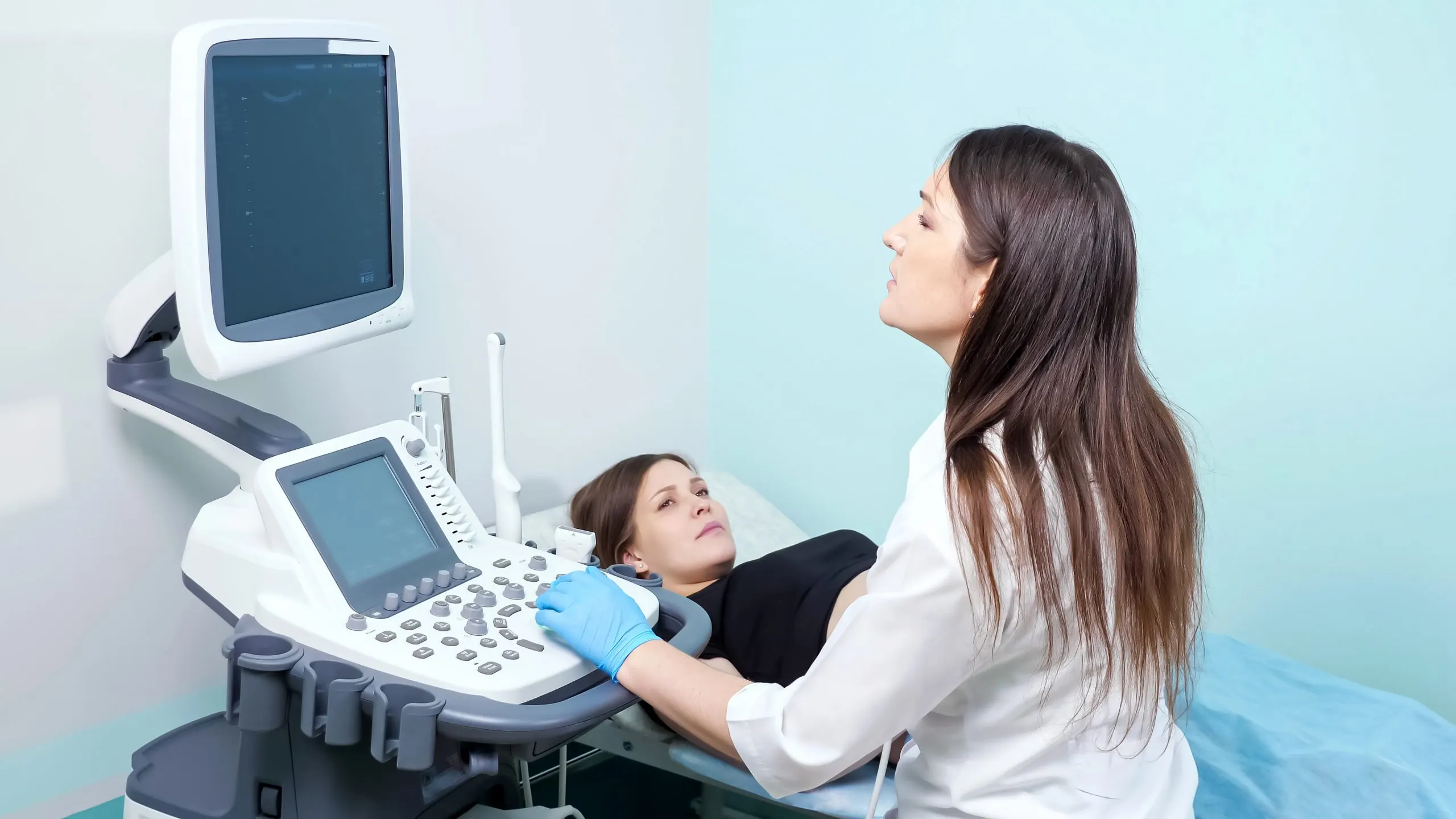 UAE Obstetric Ultrasound Equipment Market Outlook 2035 concentrated-lady-doctor-conducts-ultrasound-investigation-procedure-young-pregnant-woman-looking-screen-modern-hospital-office-scaled
