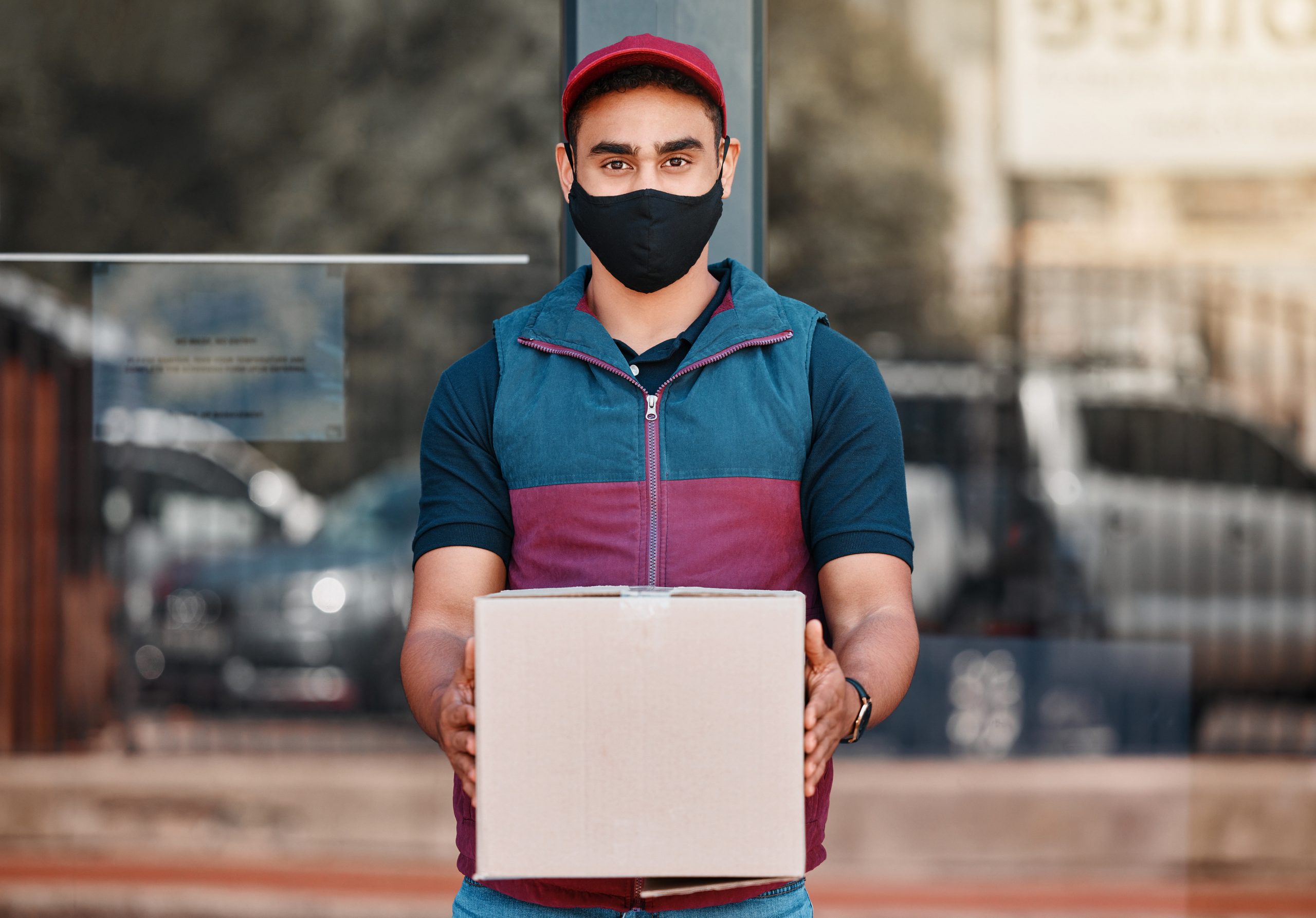 delivery-man-box-covid-face-mask-working-courier-service-with-package-shipment-parcel-outdoor-express-logistics-portrait-guy-ready-deliver-ecommerce-order-coronavirus-scaled