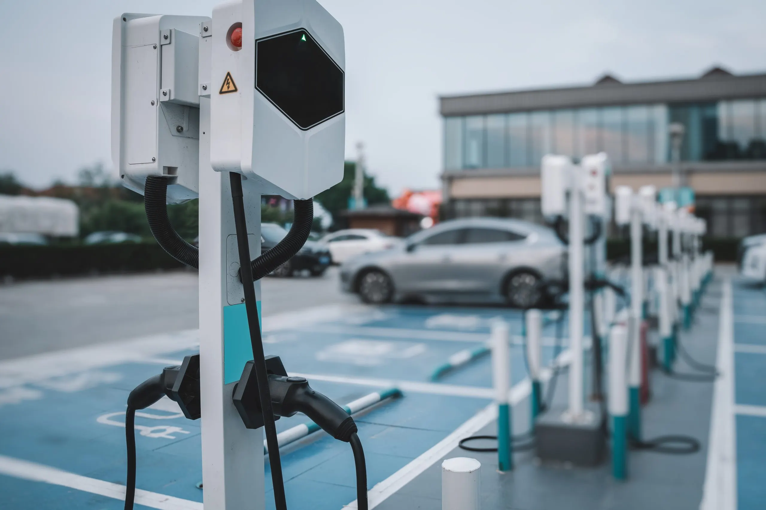 USA EV Charging Infrastructure Market Outlook to 2035 electric-vehicle-charging-station-parking-lot-1-scaled