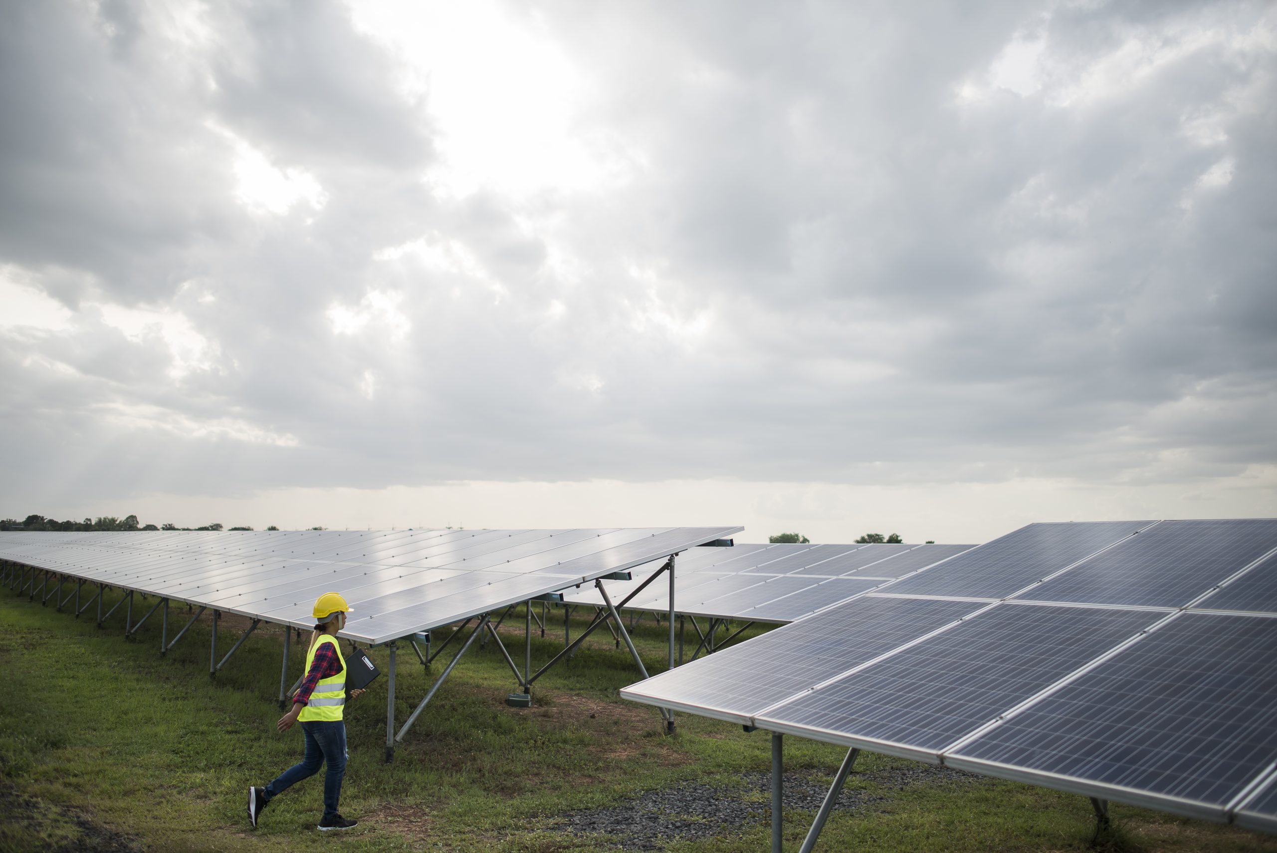engineer-electric-woman-checking-maintenance-solar-cells-scaled