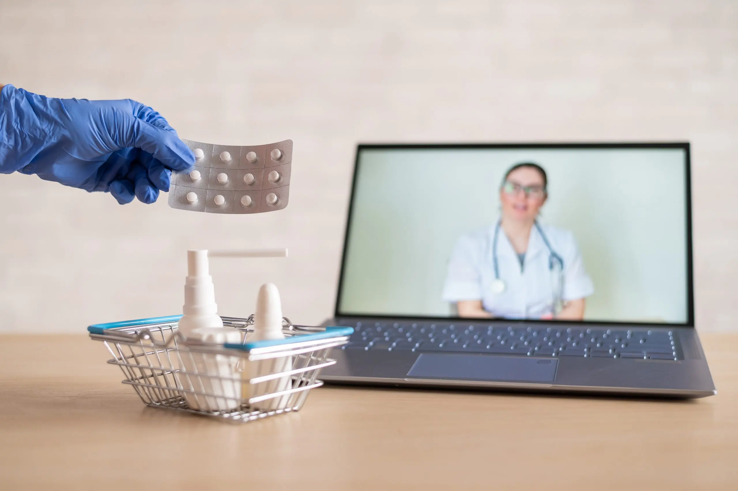 UK Telemedicine Market Outlook to 2035 friendly-doctor-conducts-online-consultation-laptop-gloved-pharmacist-puts-medicine-into-mini-shopping-cart-concept-distance-medicine-order-drugs-online-scaled