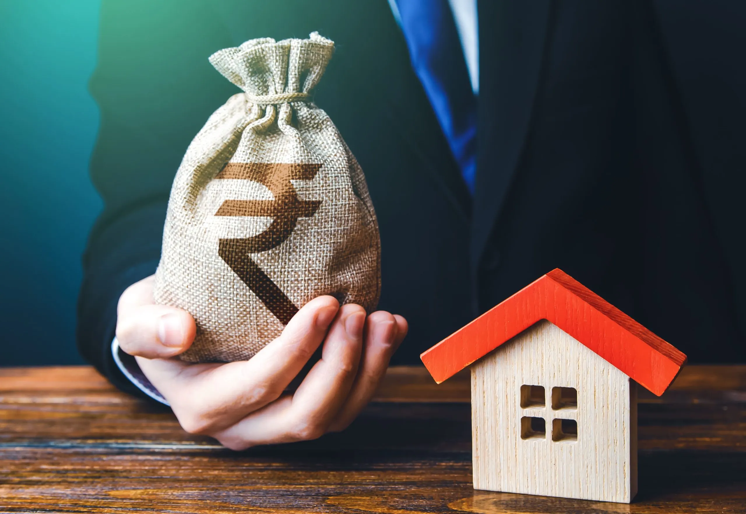 India home finance Market Outlook to 2035 man-holds-out-indian-rupee-bag-near-house-property-appraisal-favorable-terms-conditions-1-scaled