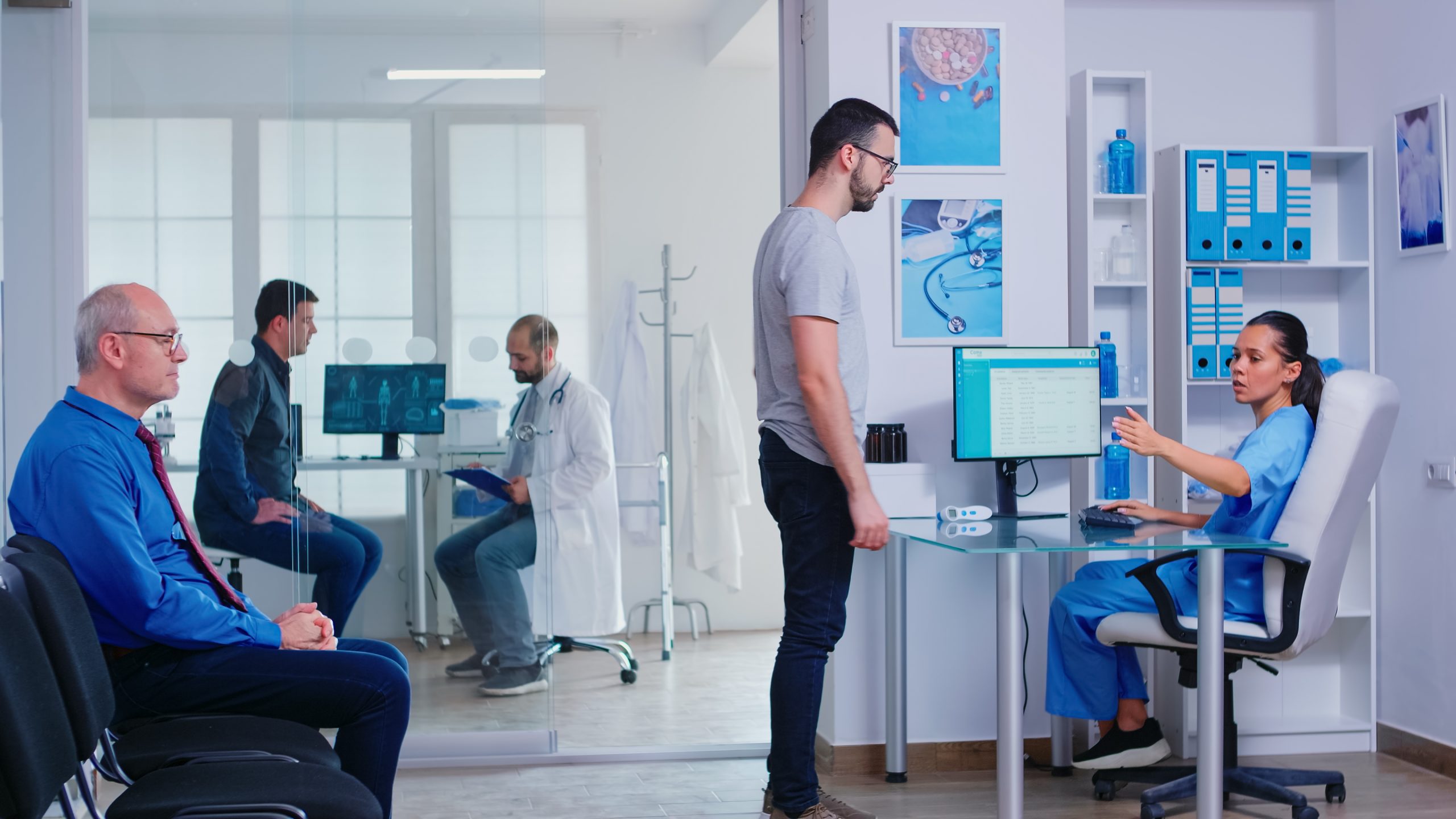 UK Healthcare Infrastructure Market Outlook to 2035 nurse-from-hospital-reception-giving-doctor-patient-radiography-assistant-pushing-disabled-senior-woman-wheelchair-through-waiting-area-man-medical-consultation-examination-room-scaled