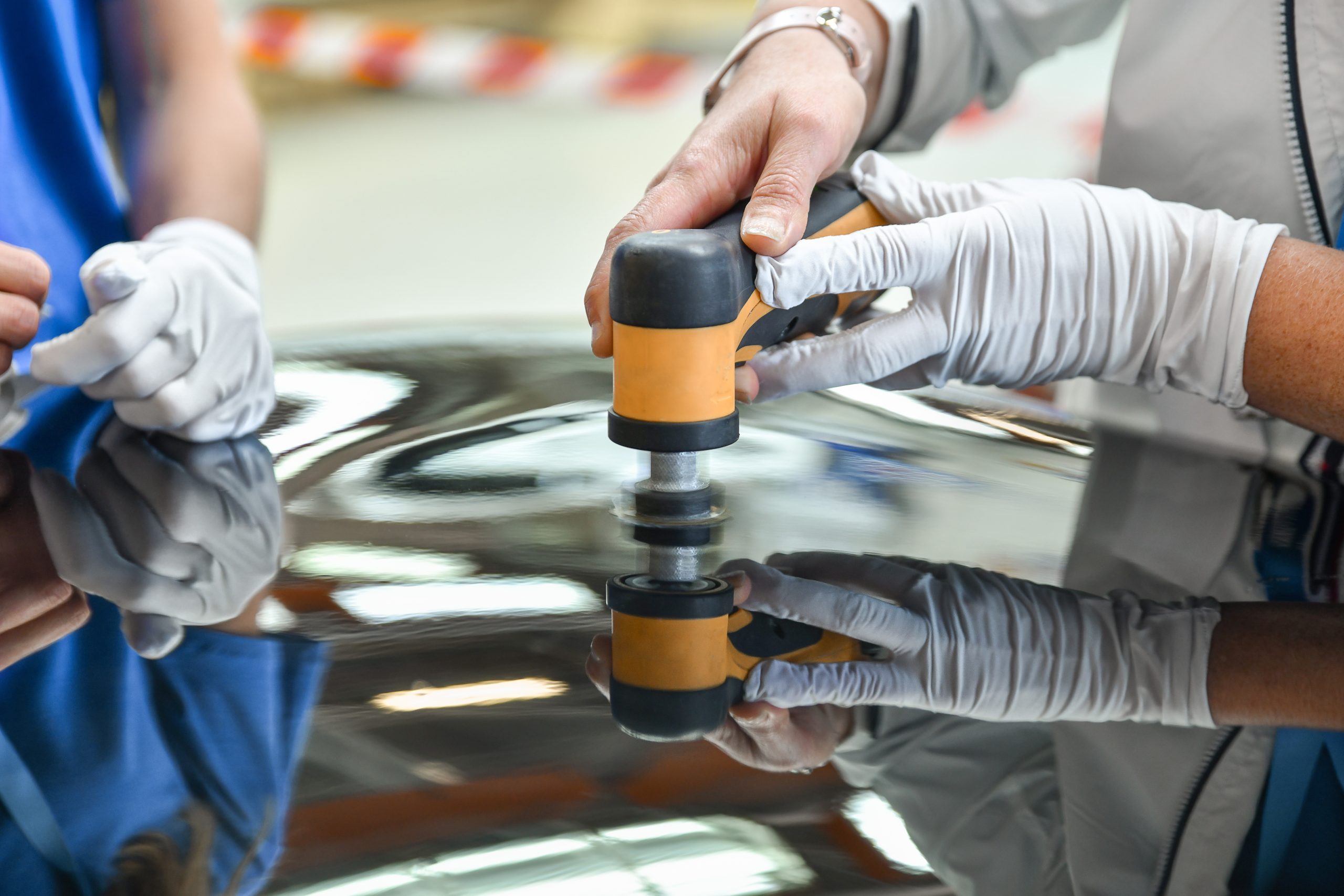 USA Automotive Adhesives Market Outlook to 2035 operator-holds-polisher-hand-scratch-scaled