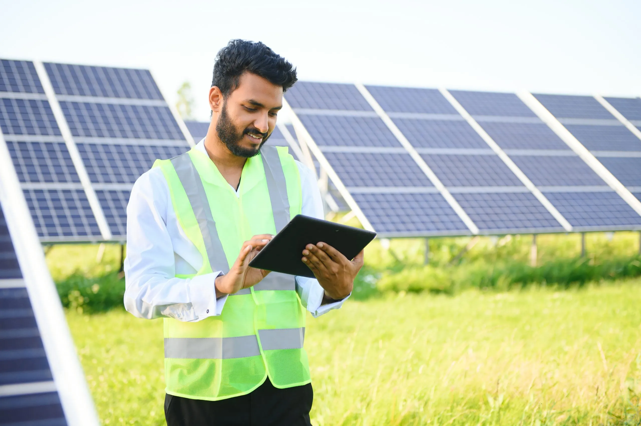 South Korea Solar EPC Market Outlook to 2035 portrait-young-indian-technician-manager-wearing-formal-cloths-standing-with-solar-panel-renewable-energy-man-standing-crossed-arm-copy-space-scaled