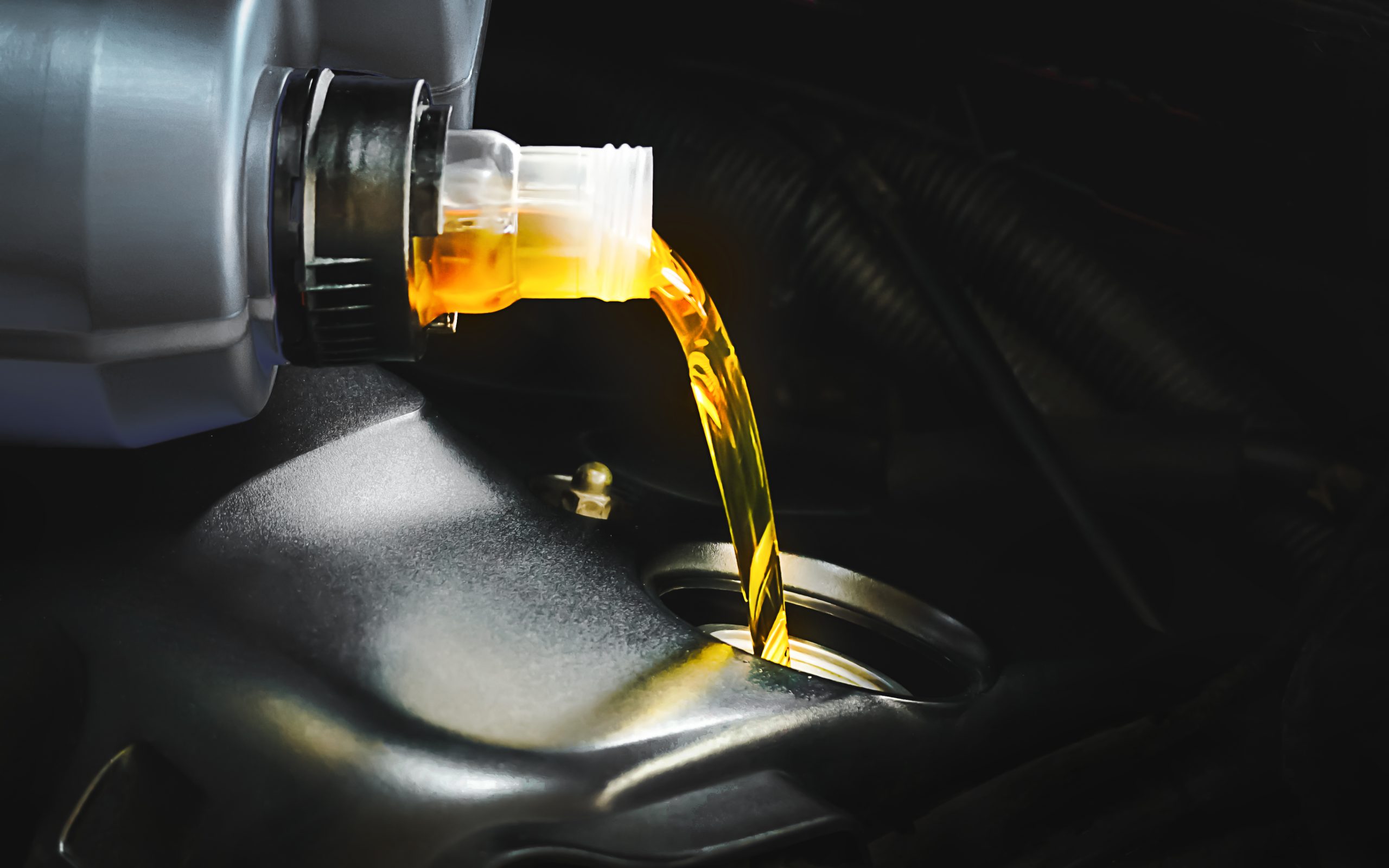 USA Automotive Engine Oils Market Outlook 2035 refueling-pouring-oil-quality-into-engine-motor-car-transmission-maintenance-scaled
