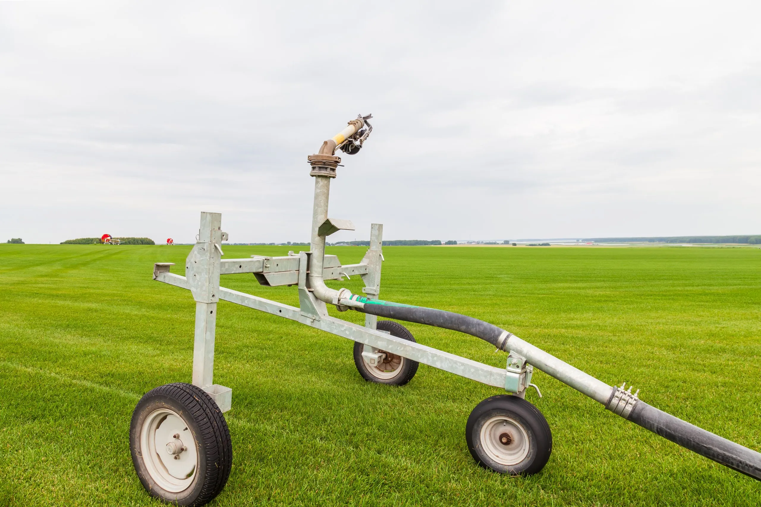 India Agricultural Hydraulic Systems Market Outlook to 2035 small-cart-with-green-label-it-sits-field-with-field-background-scaled