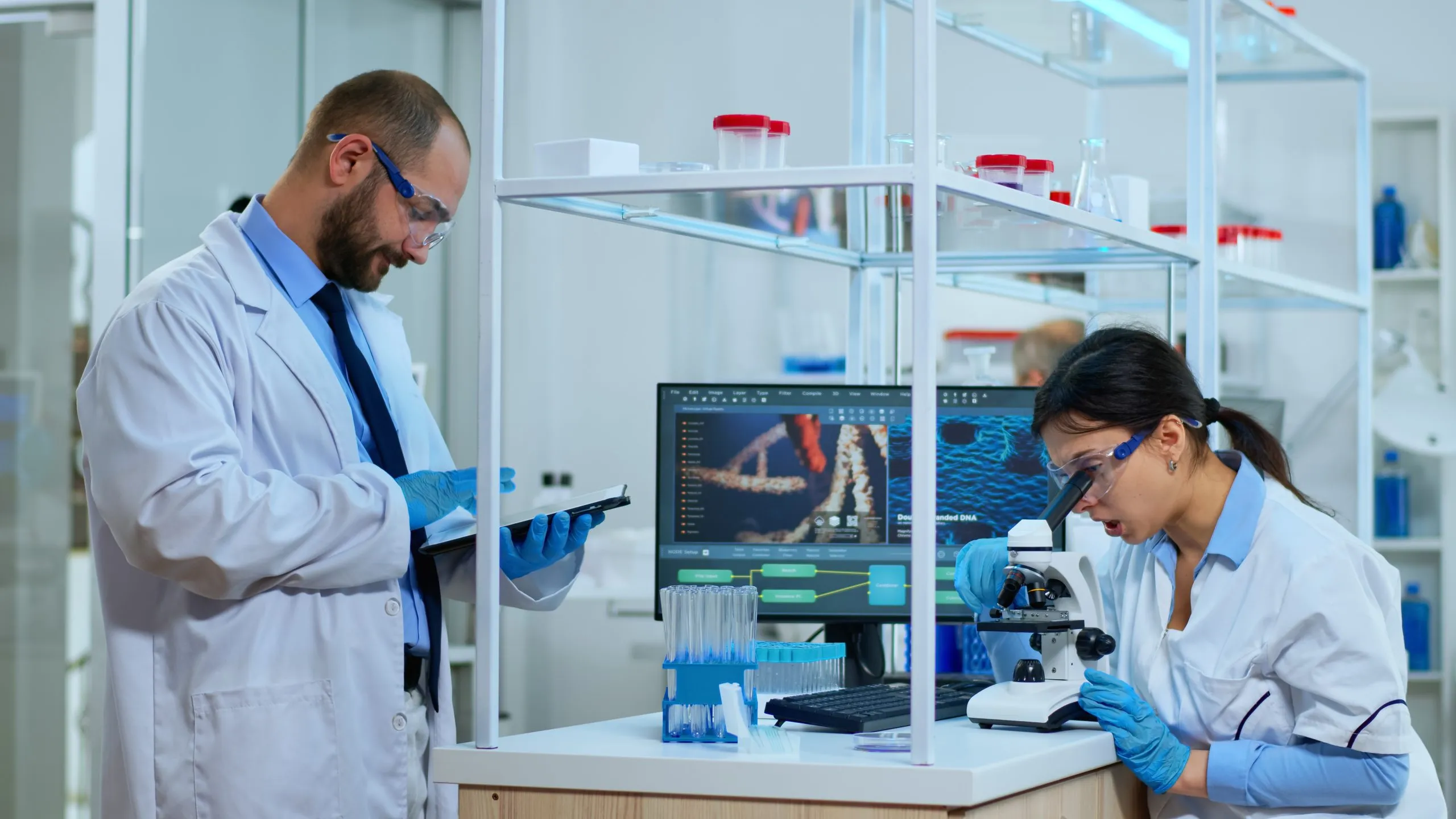KSA Diagnostic Biomarkers Market Outlook 2035 team-scientists-doing-biological-researches-microscope-lab-technician-writing-data-into-tablet-modern-equipped-laboratory-multiethnic-group-examining-virus-evolution-using-high-tech-scaled