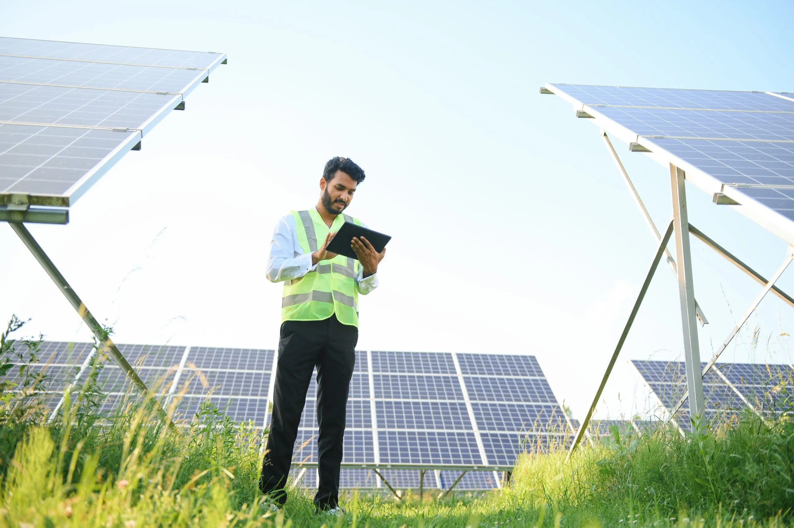 Nigeria Solar EPC Market Outlook to 2035 young-male-engineer-with-tablet-hand-standing-near-solar-panels-agriculture-farm-land-with-clear-blue-sky-background-renewable-energy-clean-energy-scaled