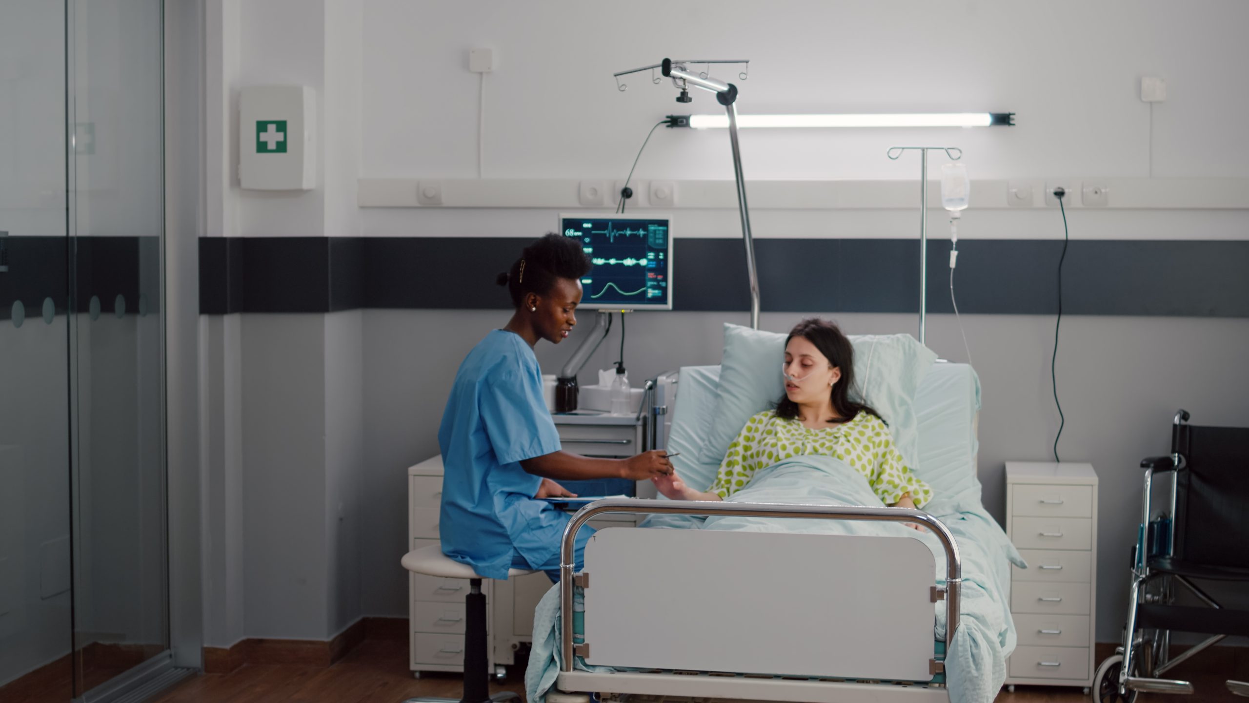 afro-american-nurse-checkup-sick-woman-analyzing-pulse-using-medical-oximeter-working-hospital-ward-scaled