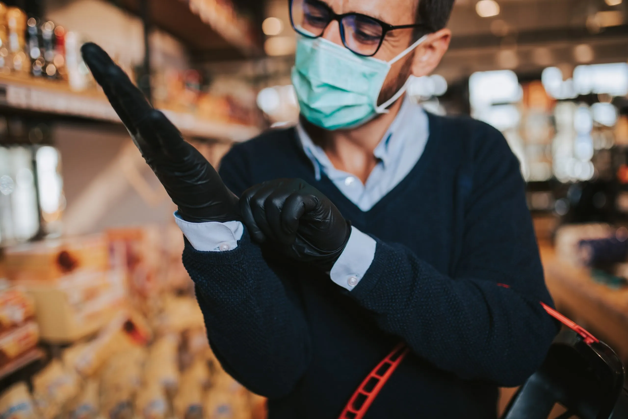 UAE hand gloves Market Outlook to 2035 casually-dressed-middle-age-man-with-face-protective-mask-gloves-buying-healthy-food-drink-modern-supermarket-grocery-store-pandemic-epidemic-lifestyle-scaled