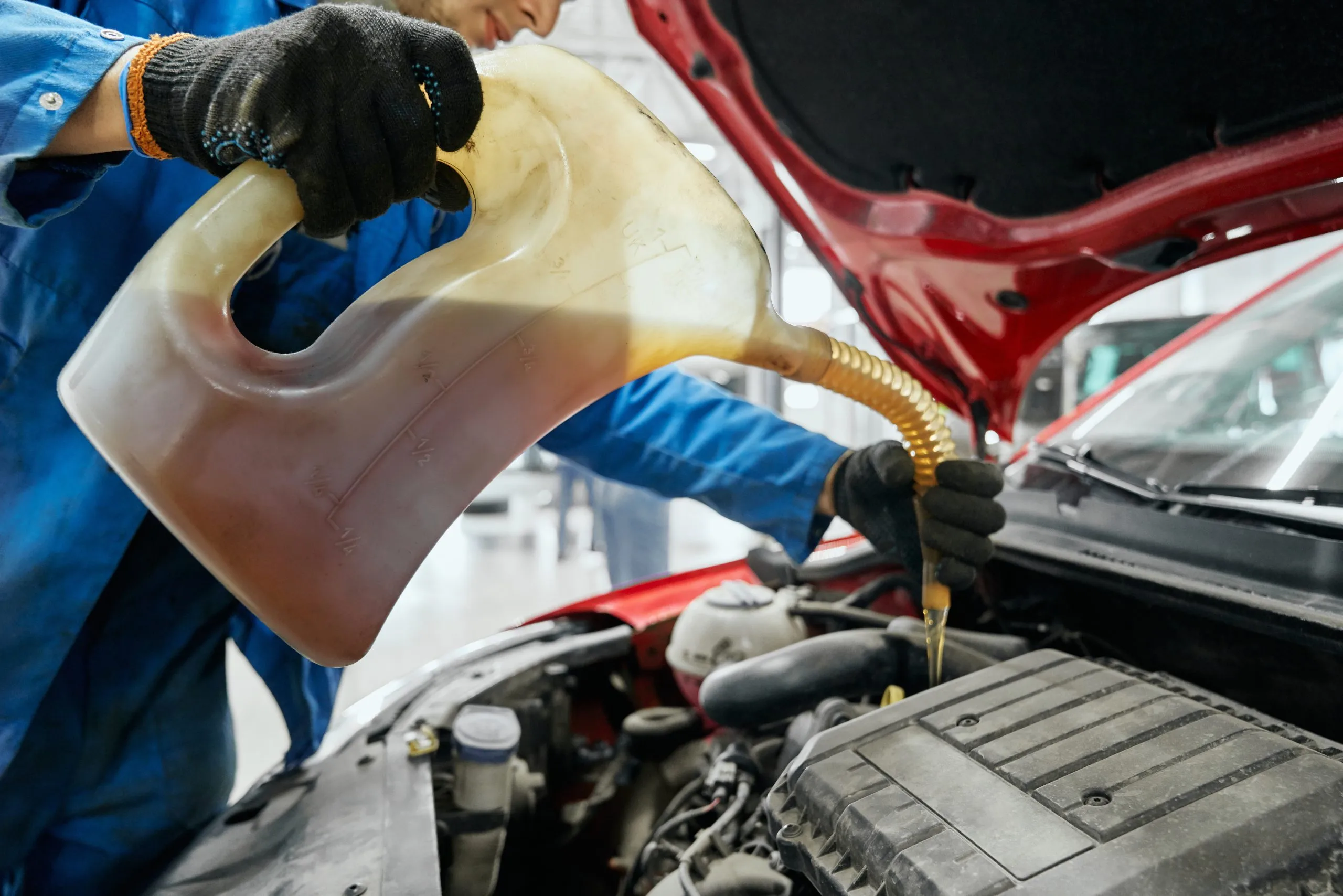 Philippines Greases Market Outlook to 2035 close-up-repairman-s-hands-black-gloves-keeping-canister-replacing-pouring-fresh-oil-into-engine-red-car-auto-maintenance-change-refuel-yellow-liquids-scaled