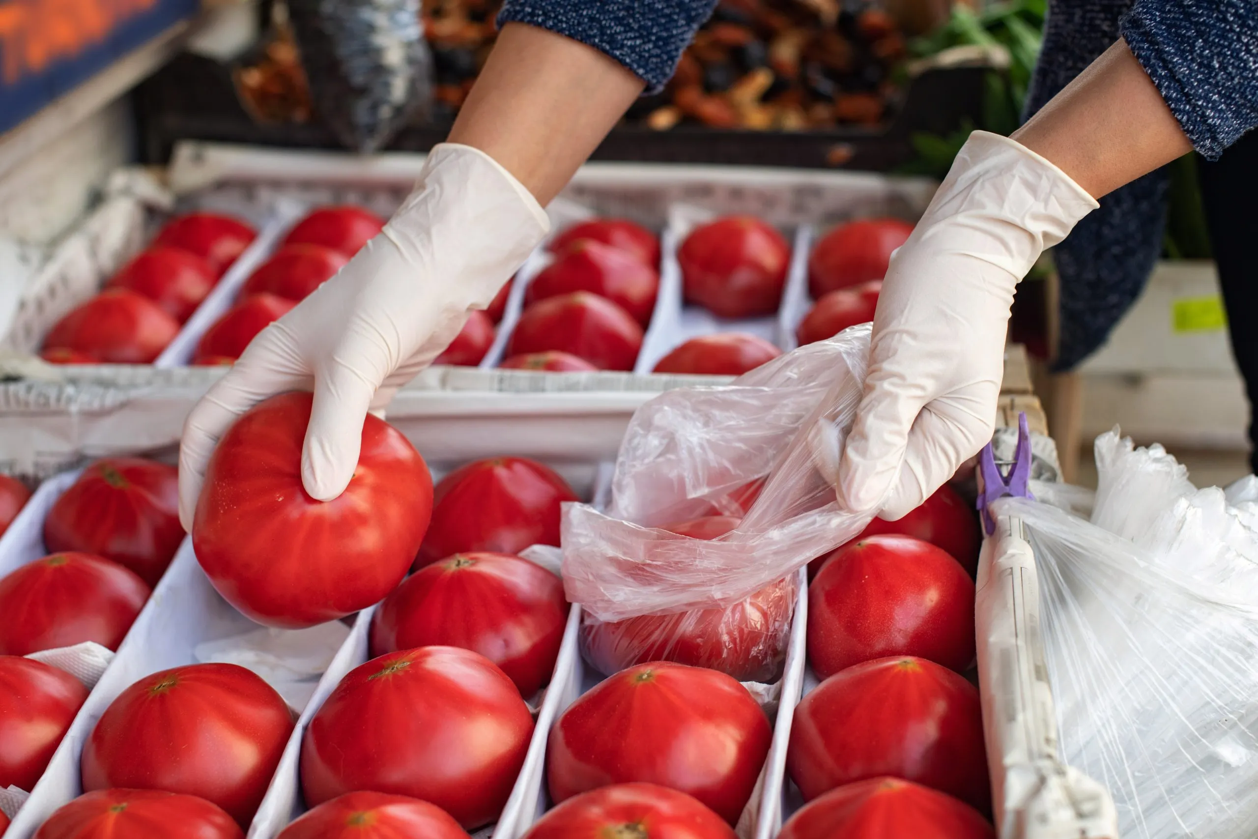 South Africa hand gloves Market Outlook to 2035 concept-safe-shopping-buying-products-woman-disposable-gloves-buys-tomatoes-scaled