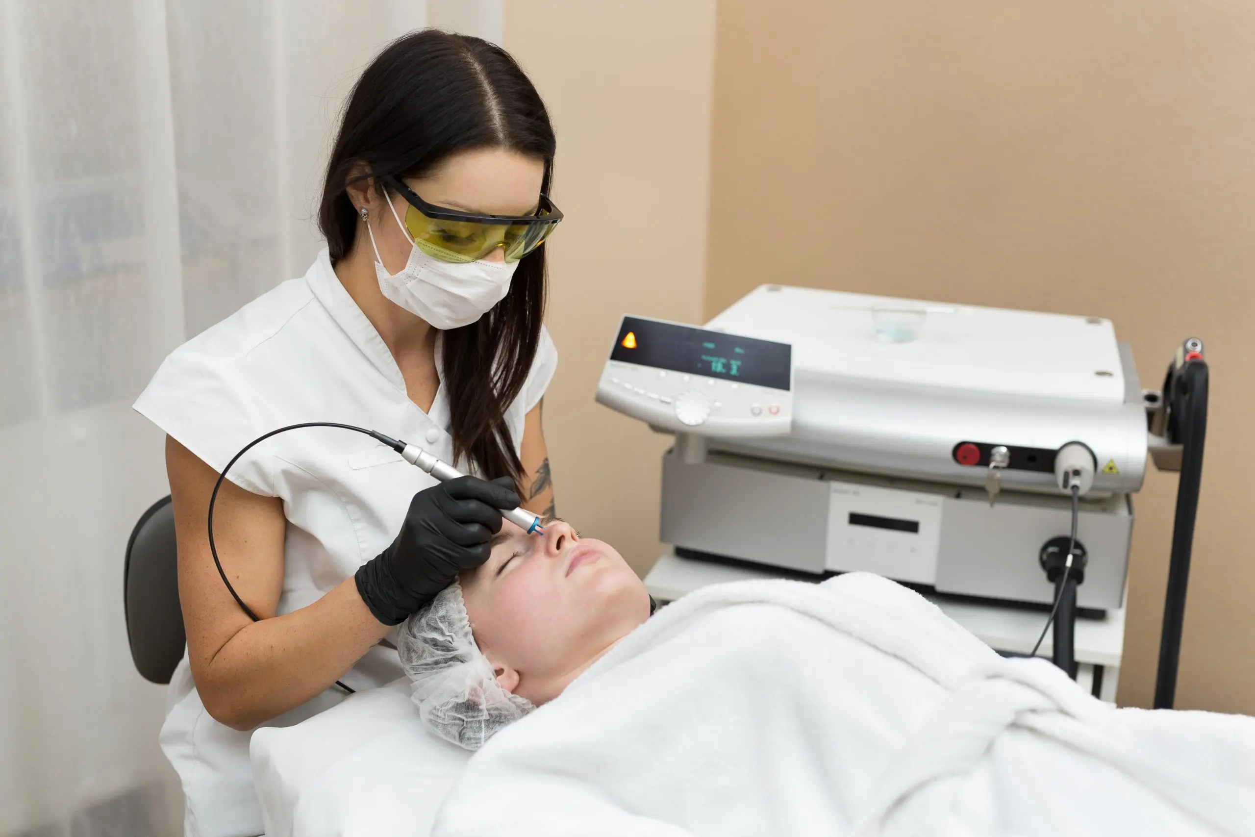 KSA Facial Rejuvenation RF Devices Market Outlook 2035 cosmetologist-protective-glasses-conducts-laser-treatment-skin-young-patient-scaled