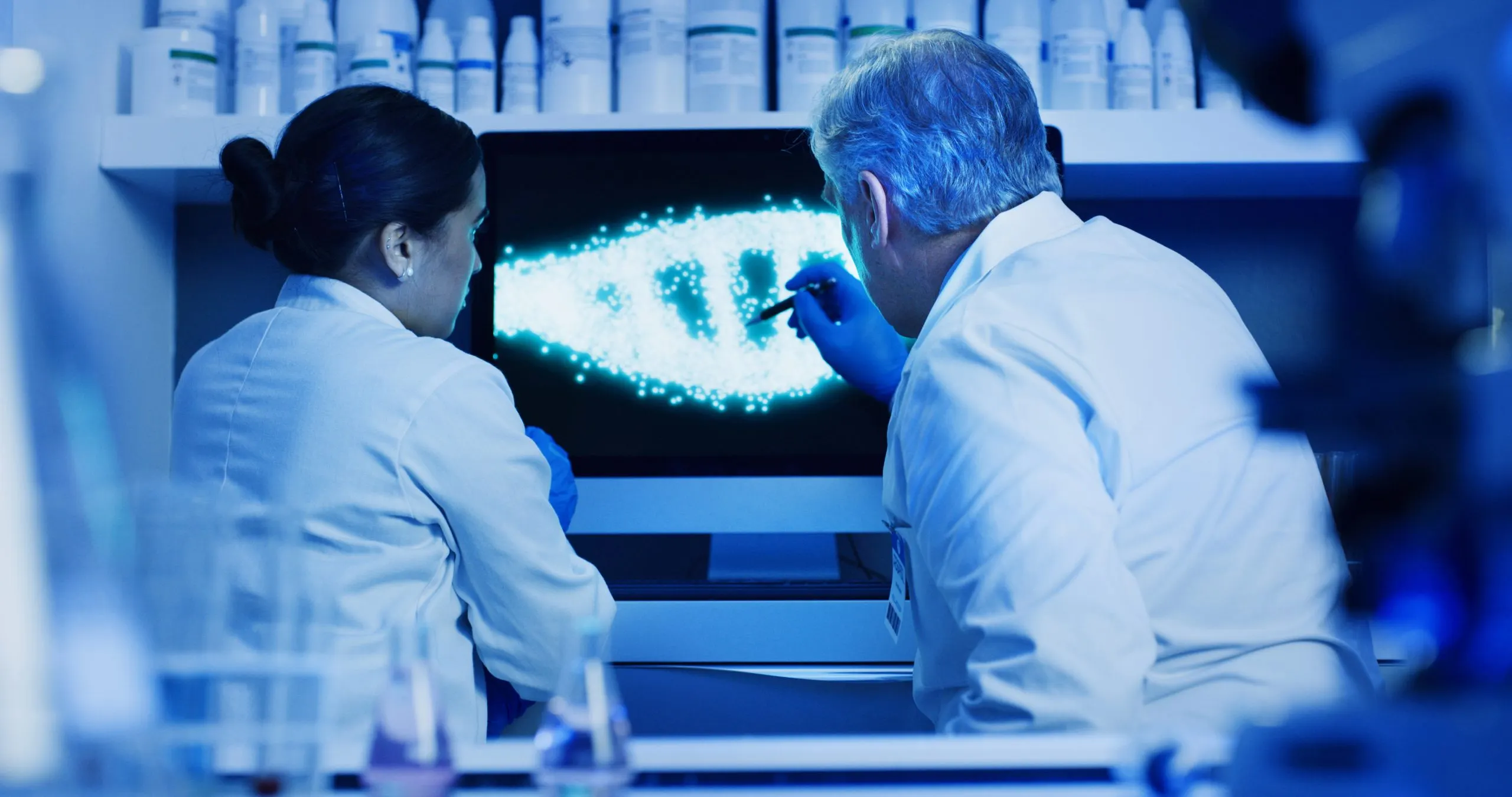 USA Next-Generation Sequencing Market Outlook 2035 dna-scientists-team-with-monitor-lab-pointing-molecular-research-innovation-web-collaboration-biochemist-people-with-computer-analysis-screen-genetic-engineering-scaled