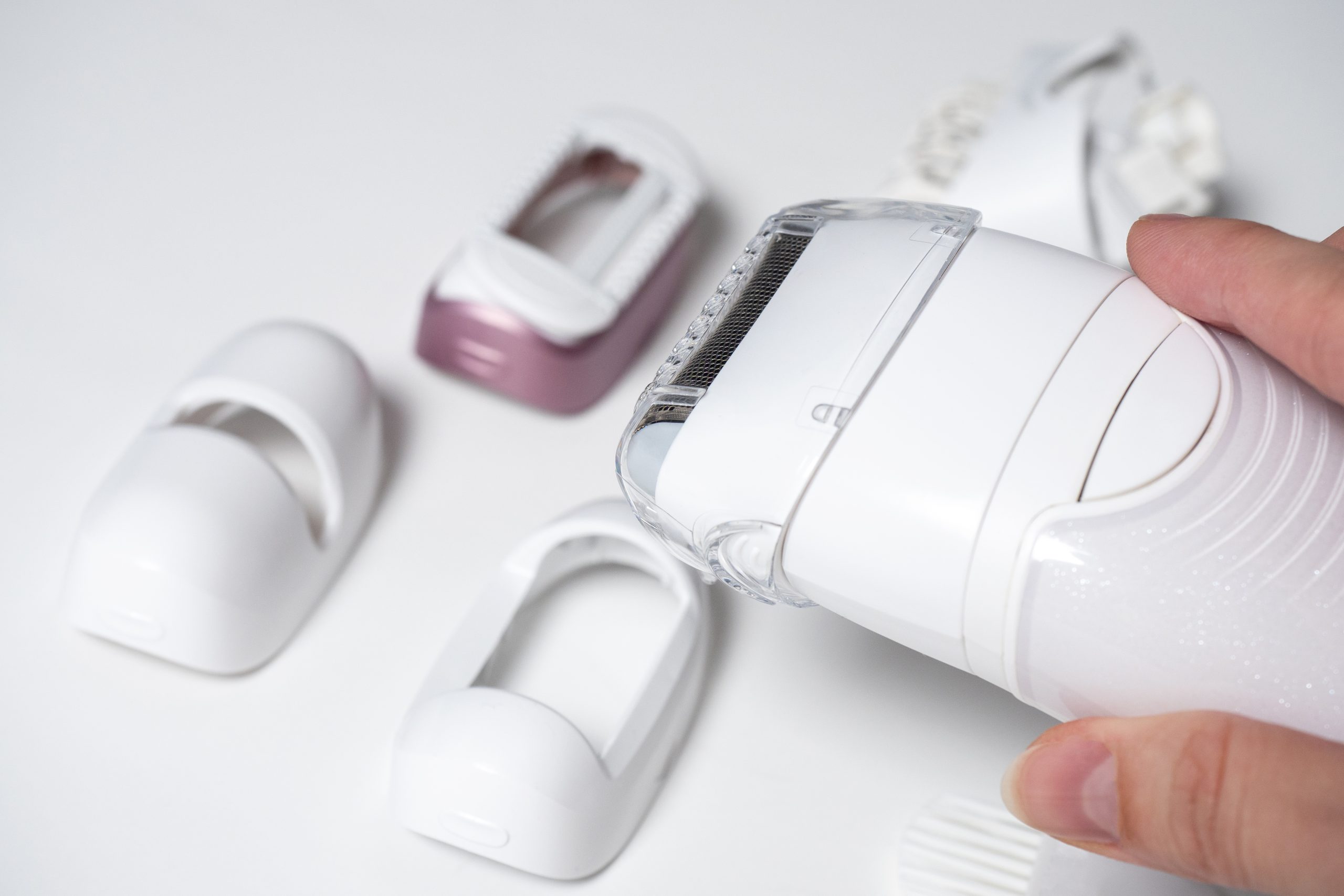 electric-epilator-woman-s-handin-background-various-nozzles-are-out-focus-devices-women-s-beauty-scaled